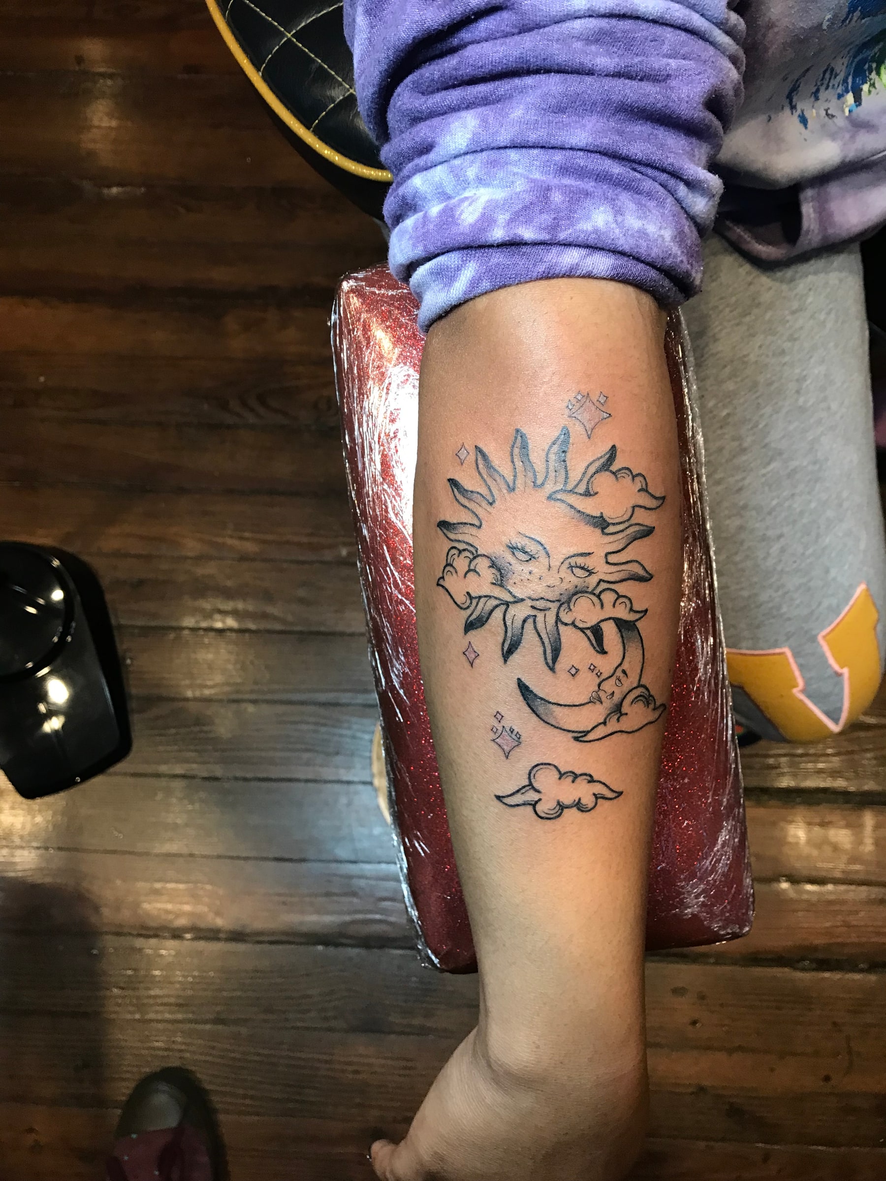 Sun and moon calf tattoo by Rob Scotti