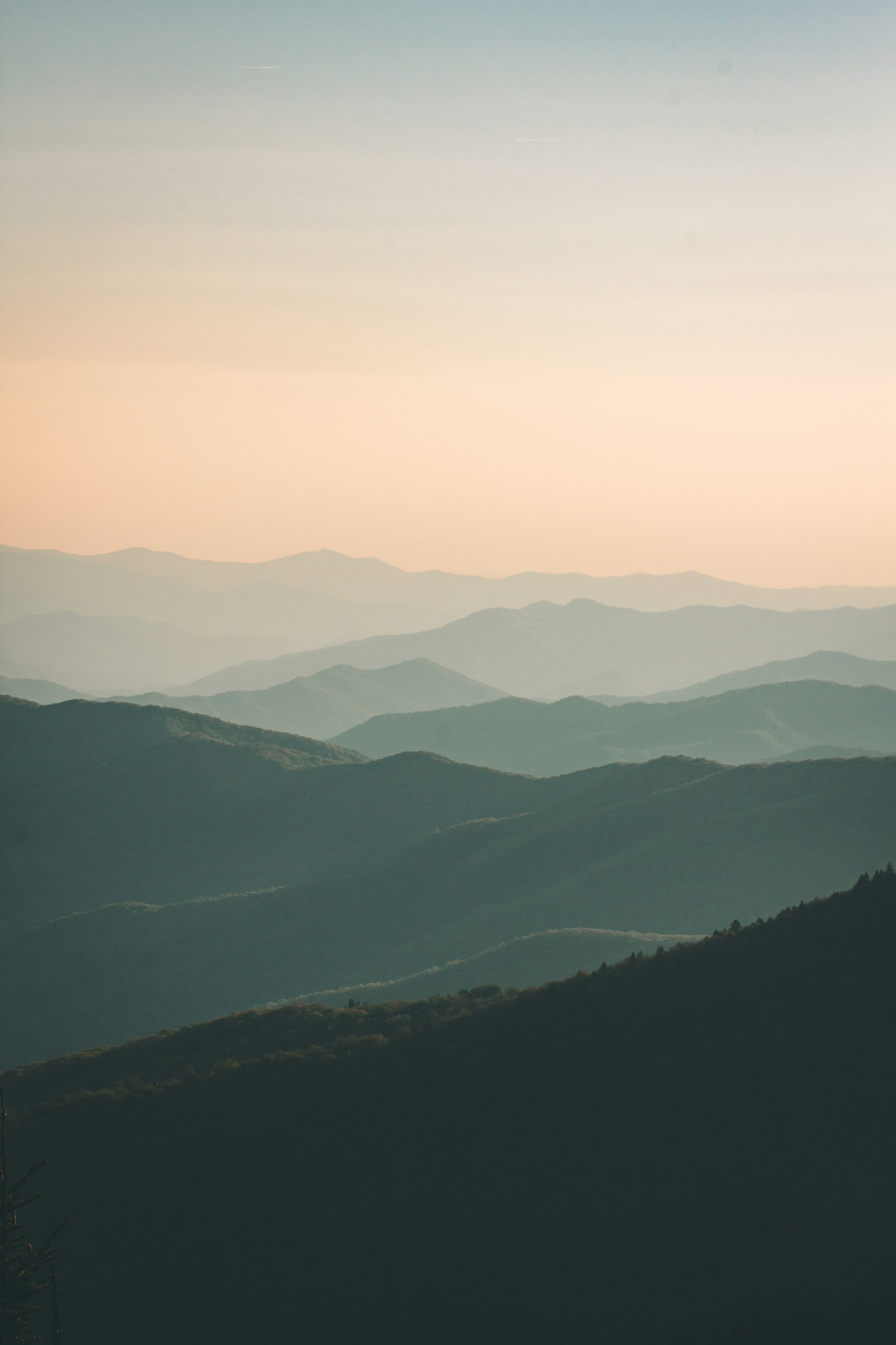 Layers of blue mountains beneath a quiet sky