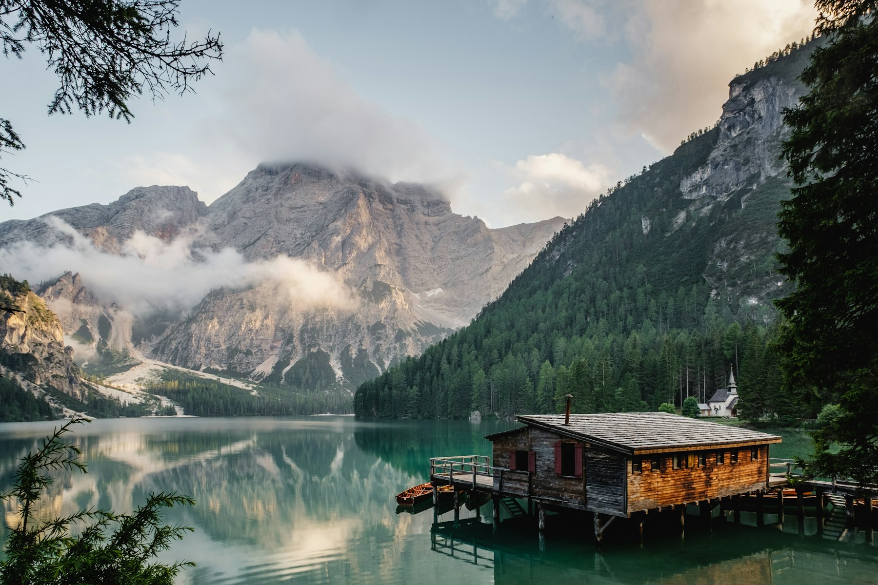 A quiet mountain lake beneath low clouds