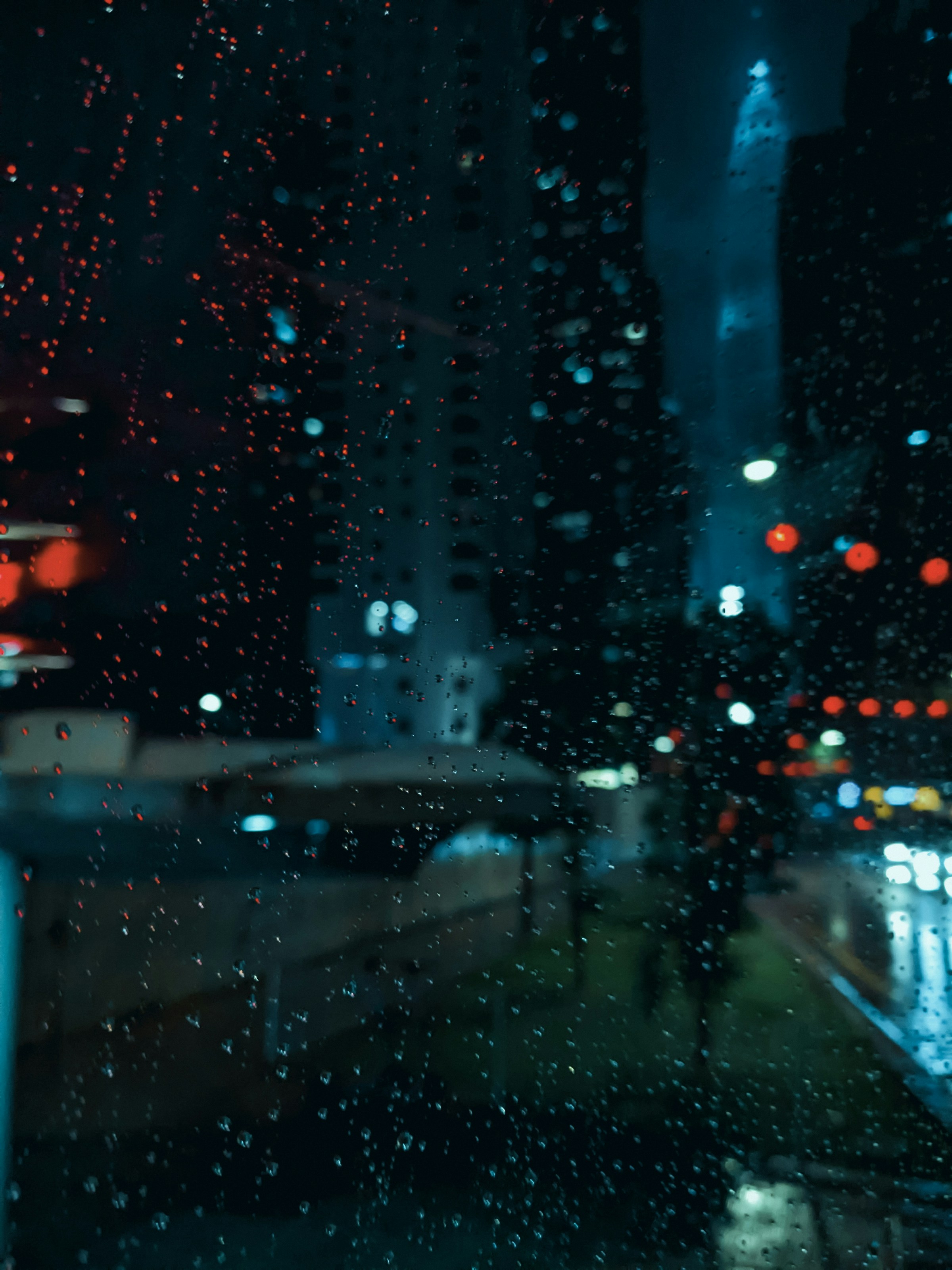 City lights blurred through a rain-covered window
