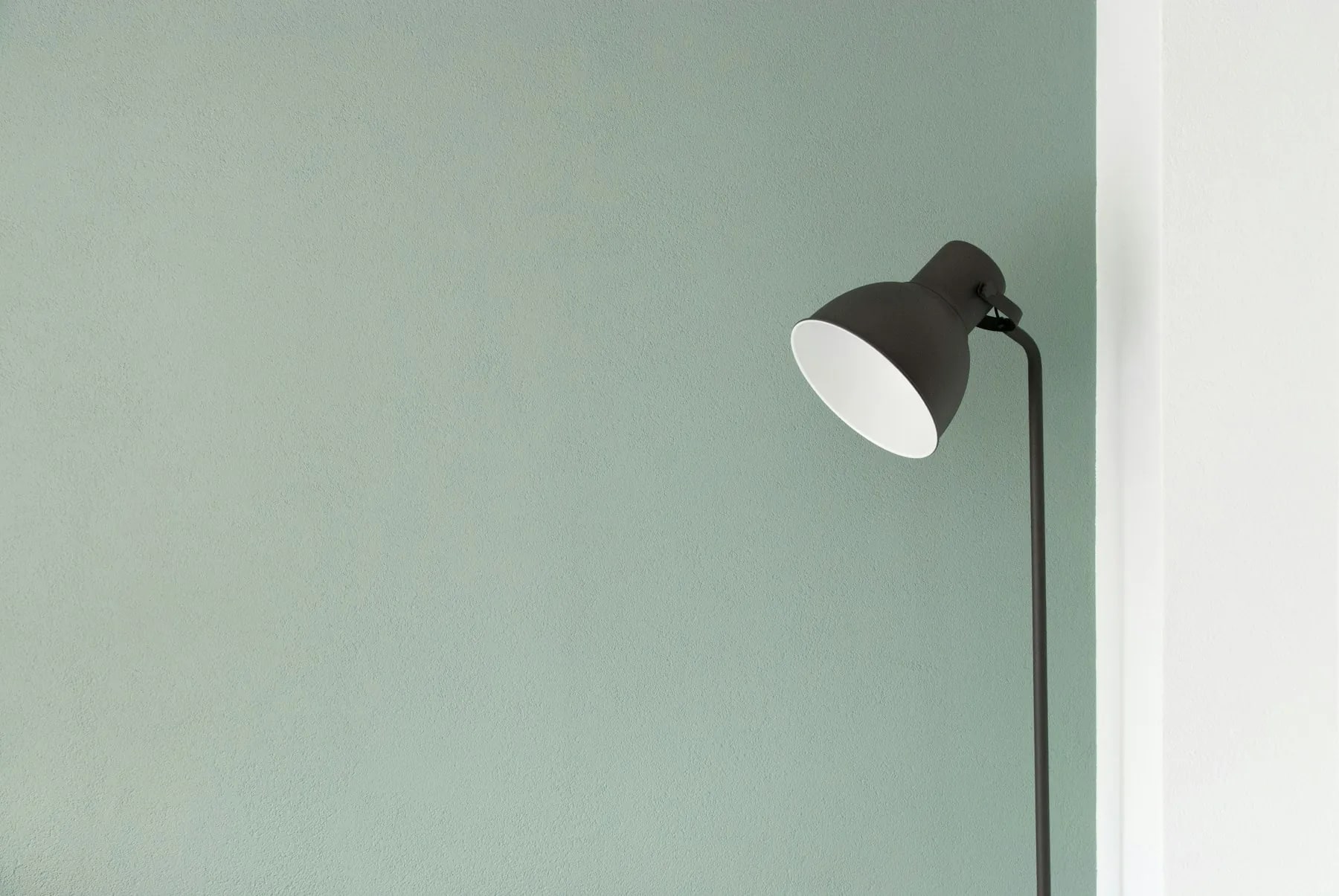A single lamp beside a quiet window