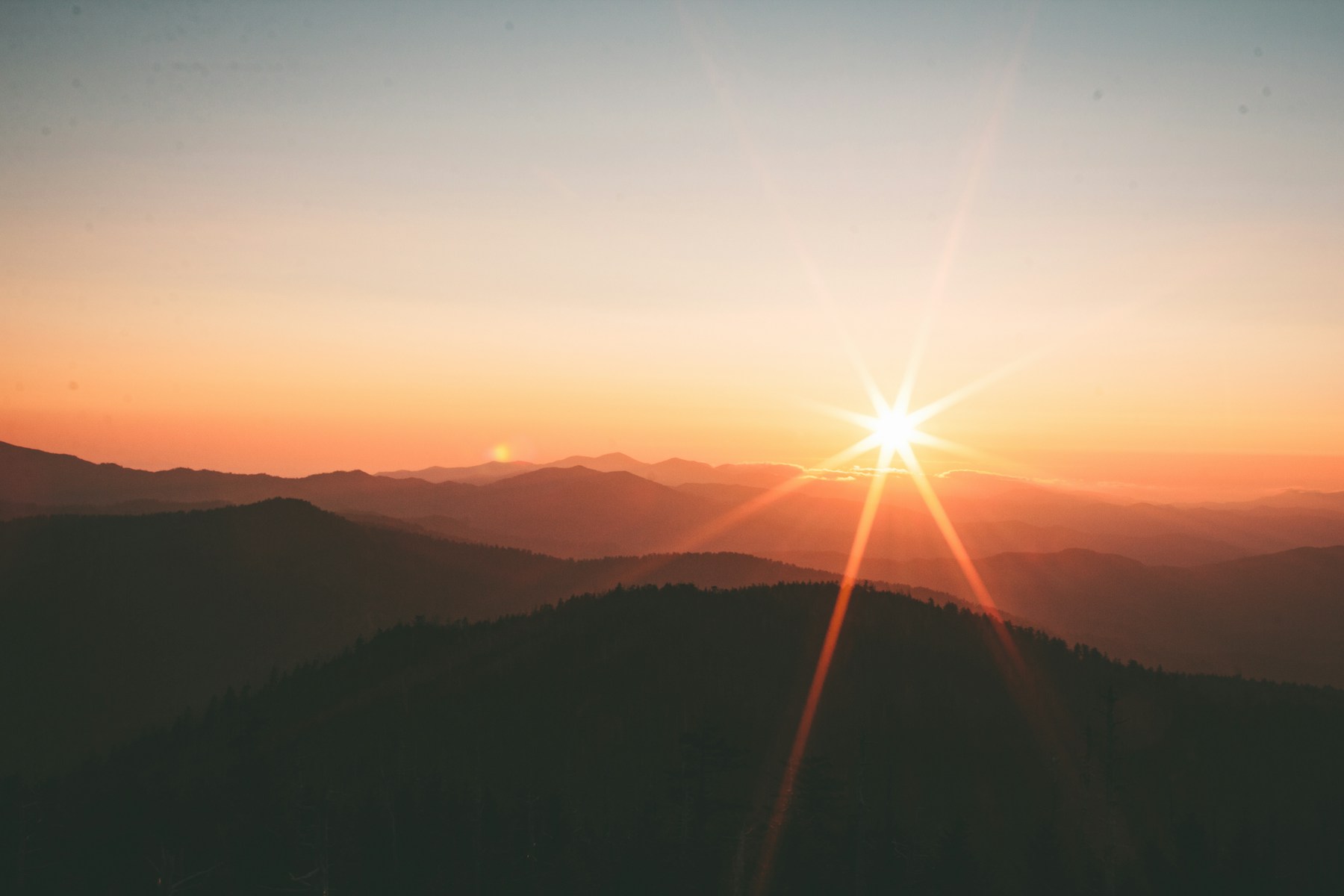 Morning sun over layers of mountains