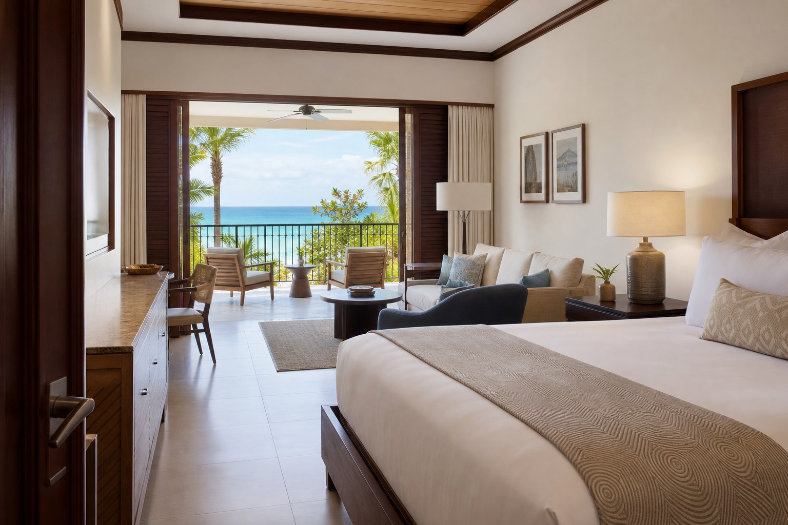 Spacious tropical resort suite with a balcony overlooking the ocean