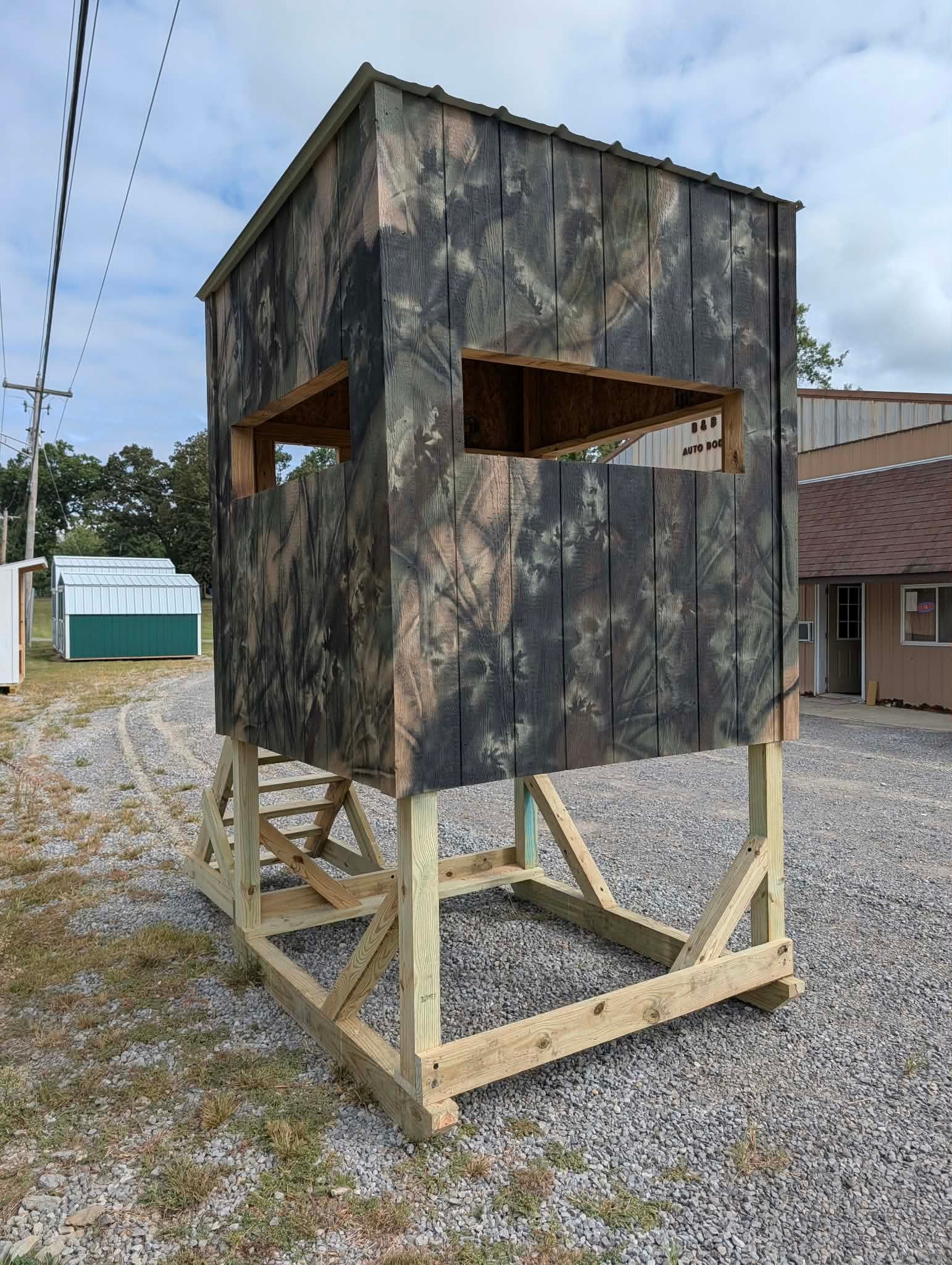 Elite Outdoors camouflage hunting blind with raised treated lumber base