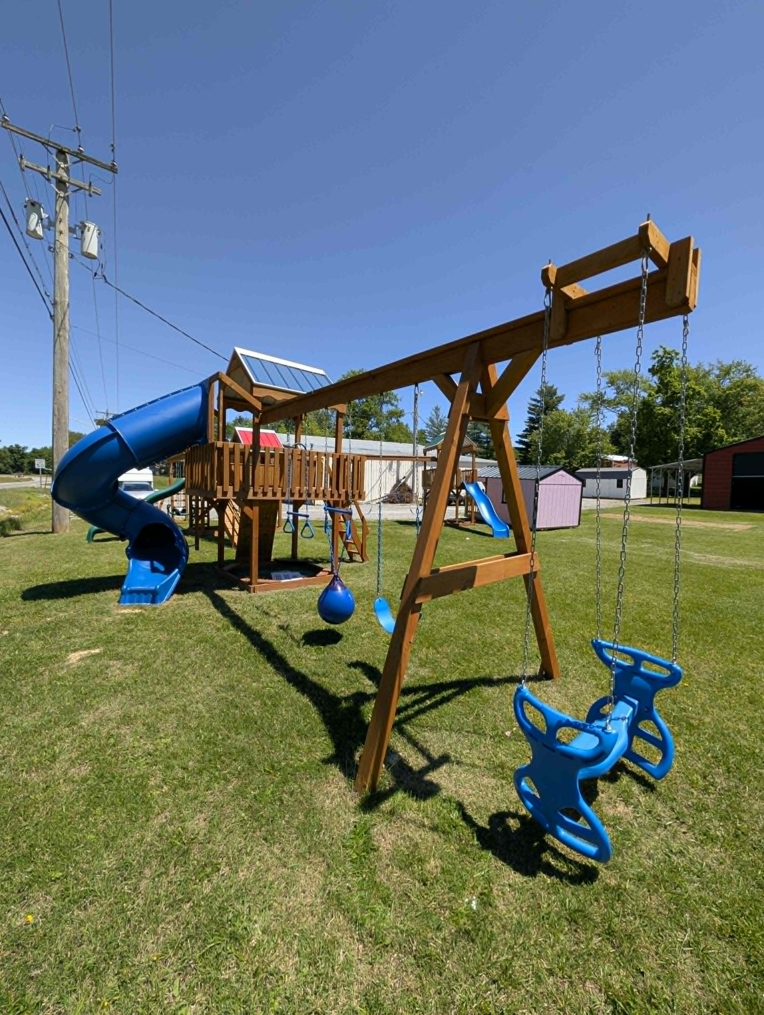 Wooden playset with a clubhouse and swings