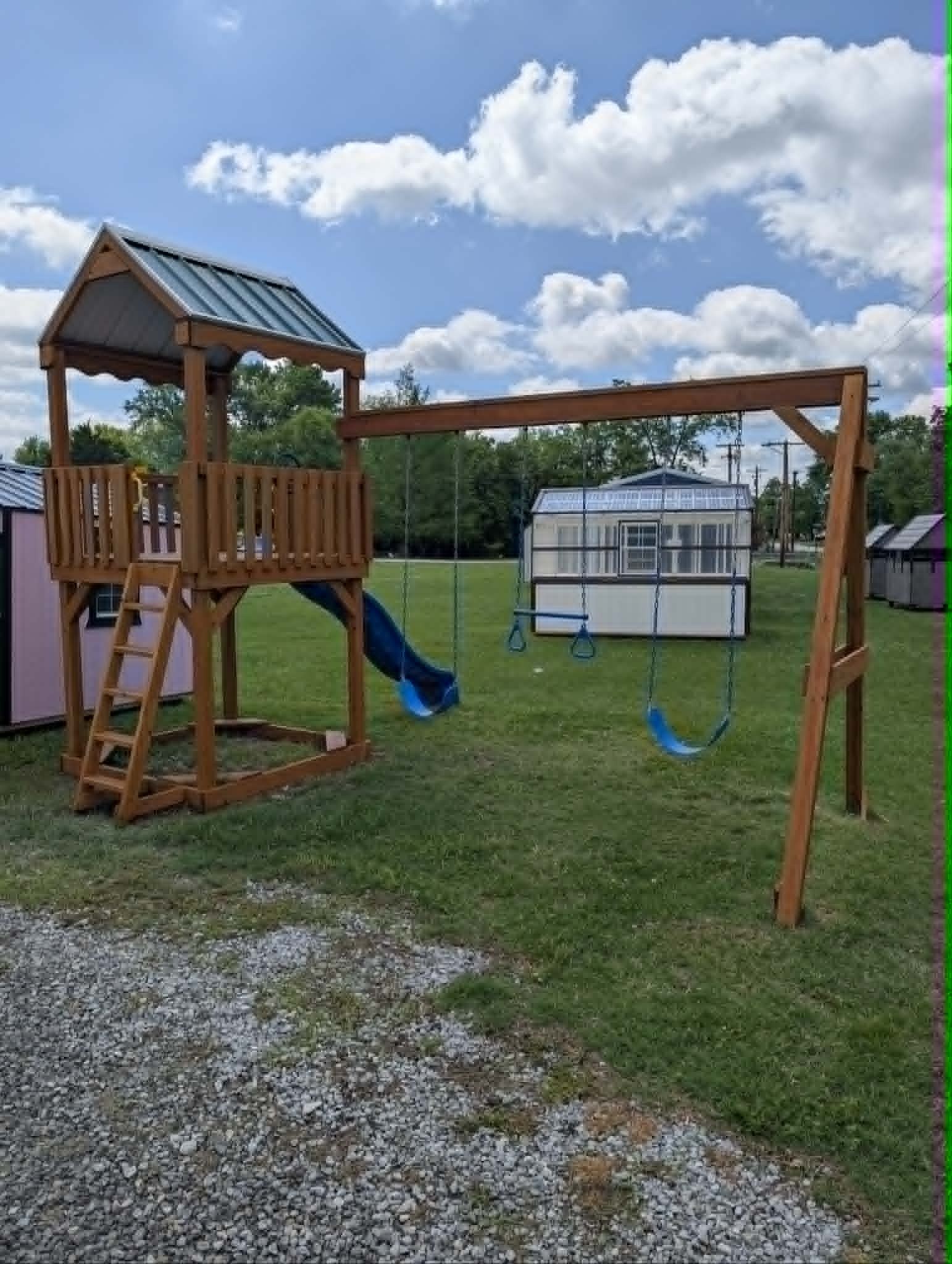 Wooden playset with blue tube slide and swing set