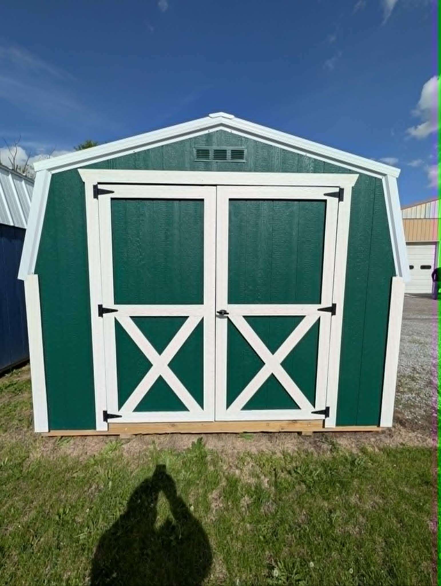 Green portable shed with double doors
