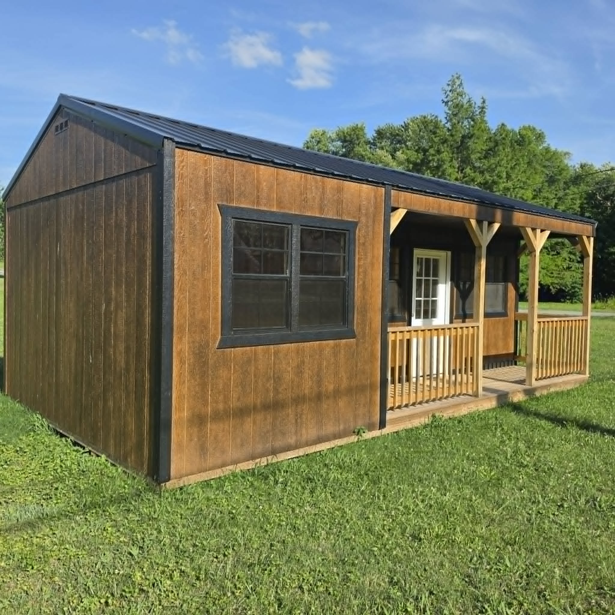 Cabin-style portable building with porch