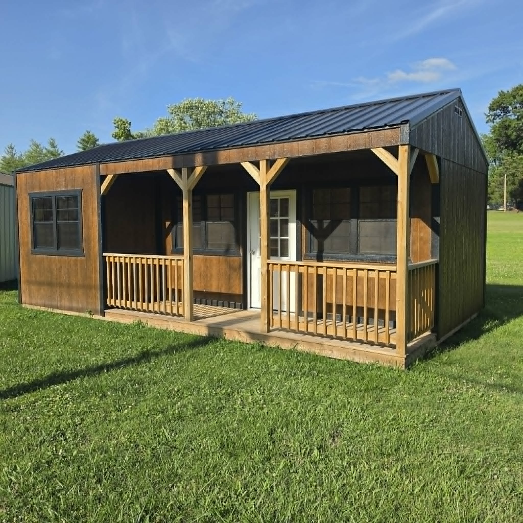 Cabin-style portable building with wide porch