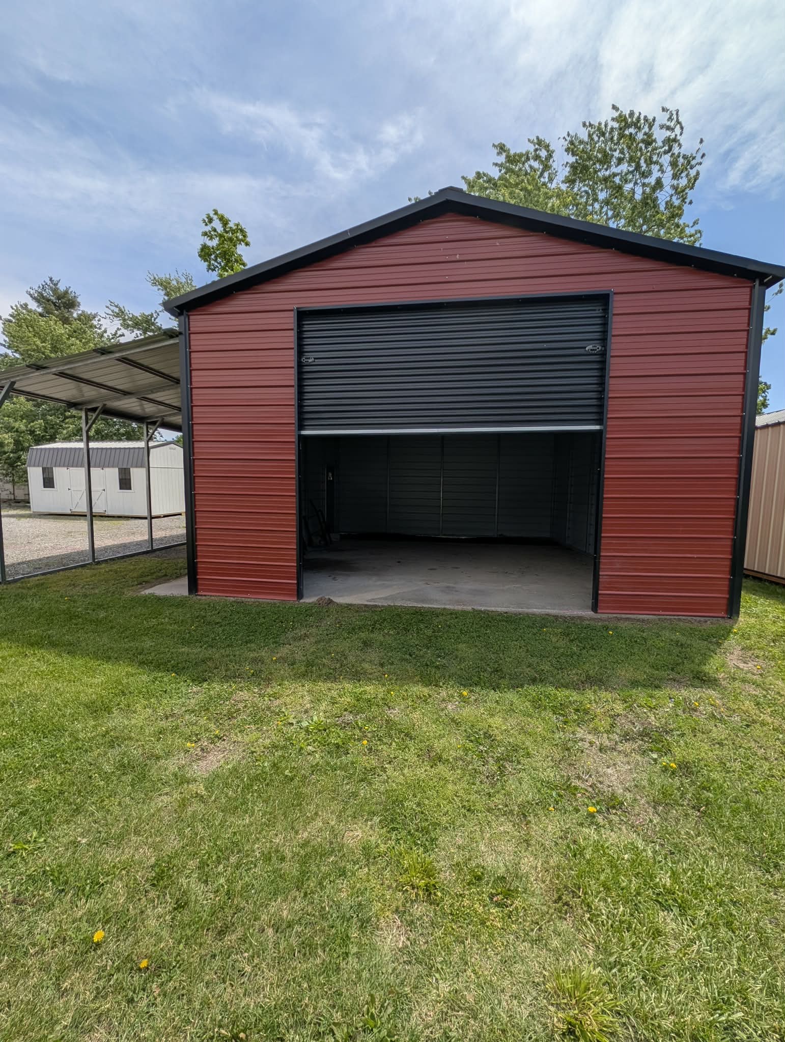 Red steel garage with a roll-up door