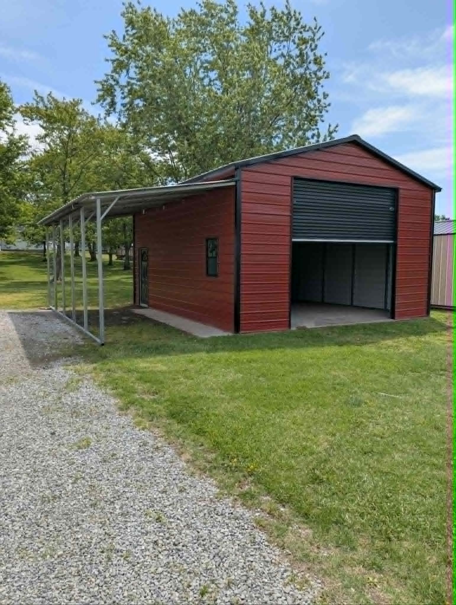 Red steel garage with a carport extension