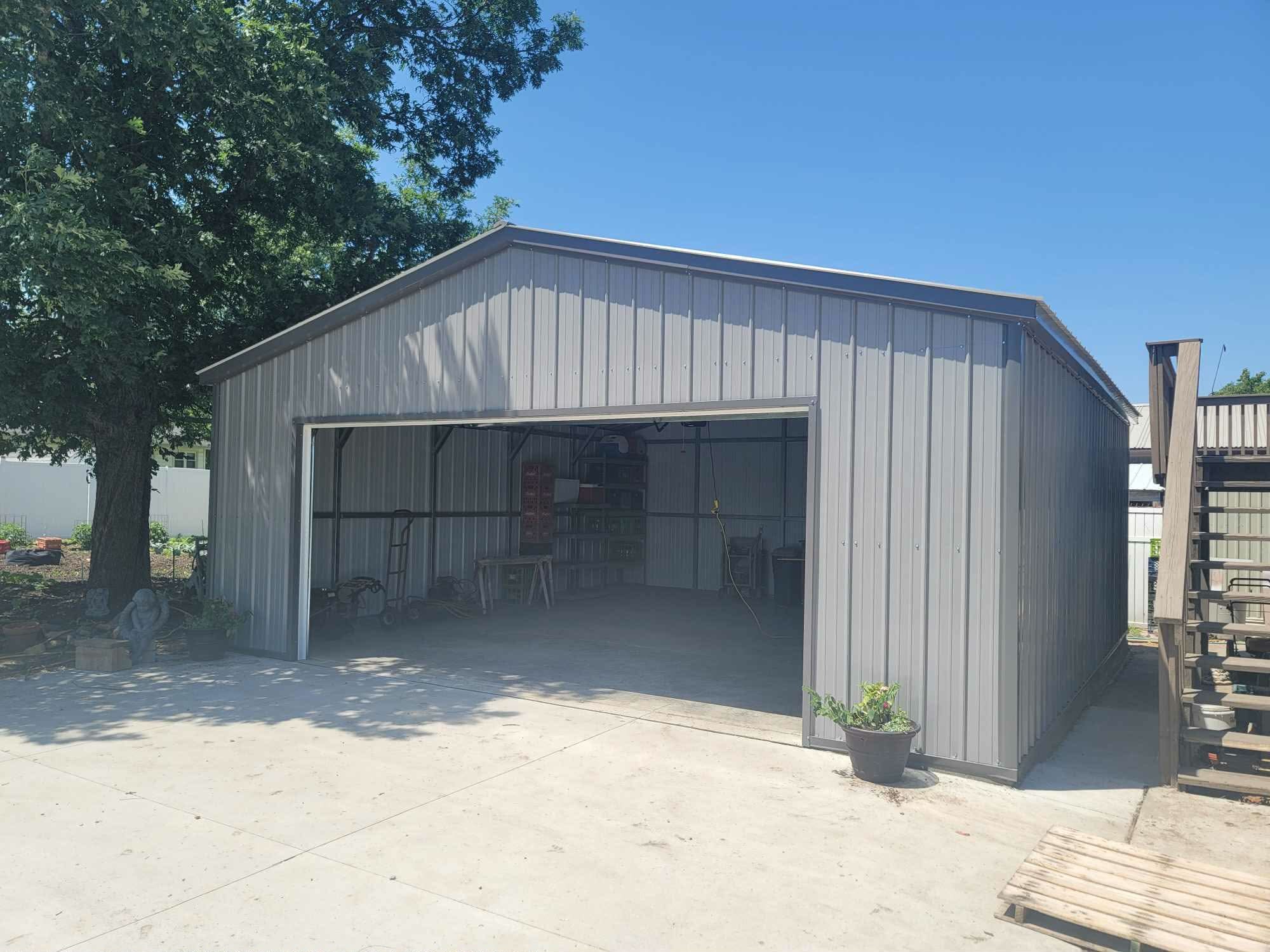 Gray steel building with a large open bay