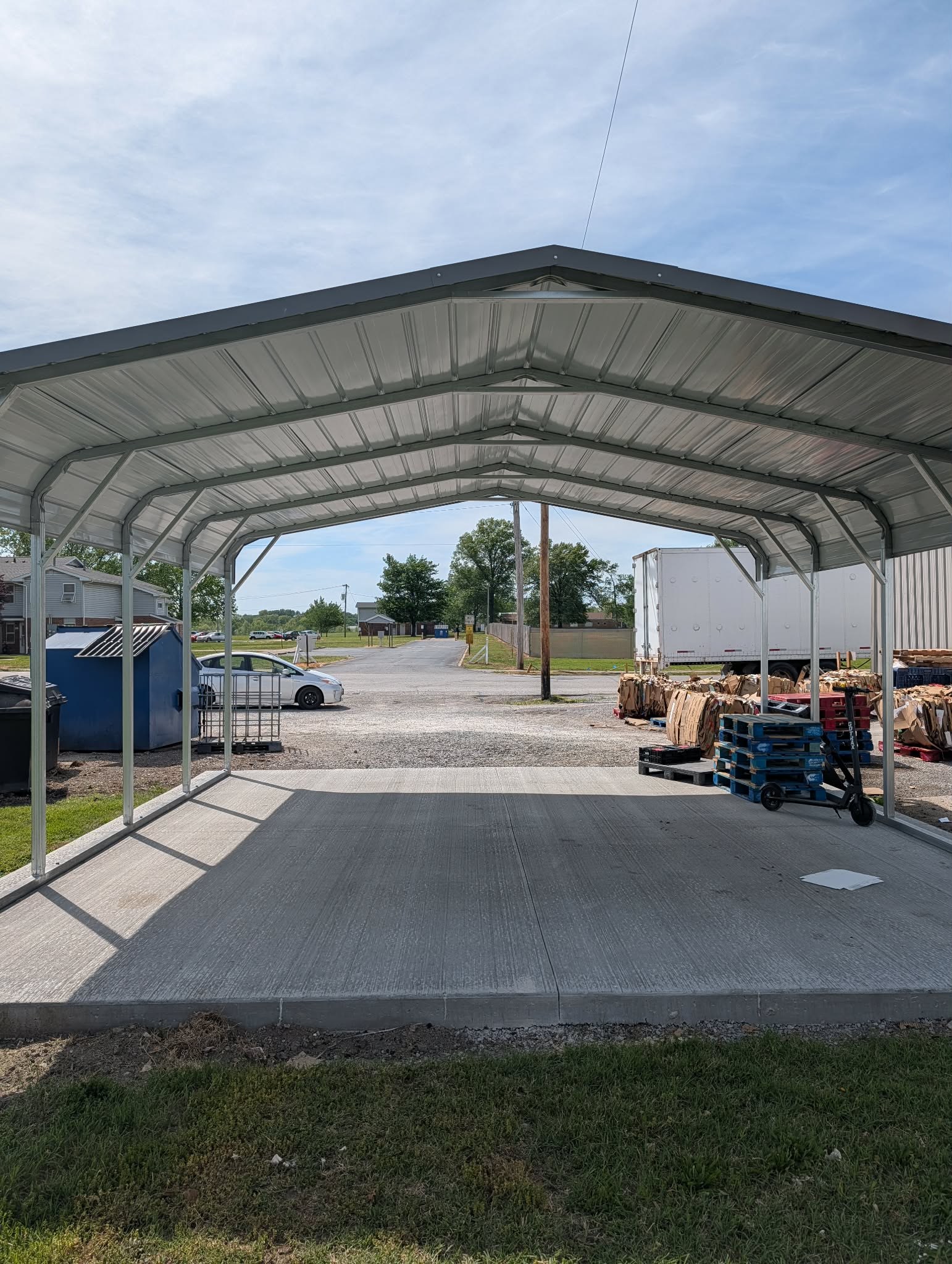 Open steel carport with a wide roof