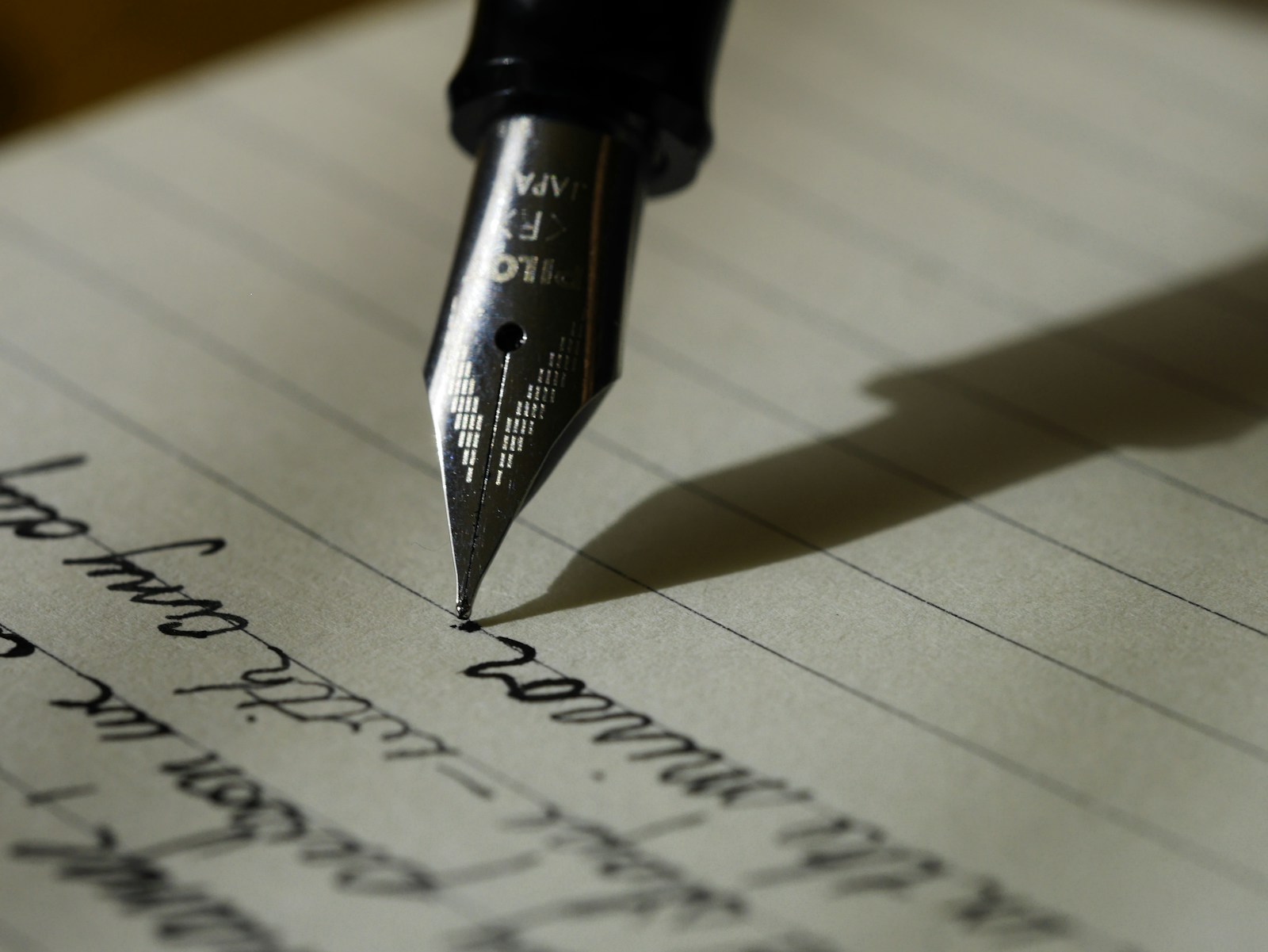 Fountain pen writing in a lined notebook, representing careful planning and measurement