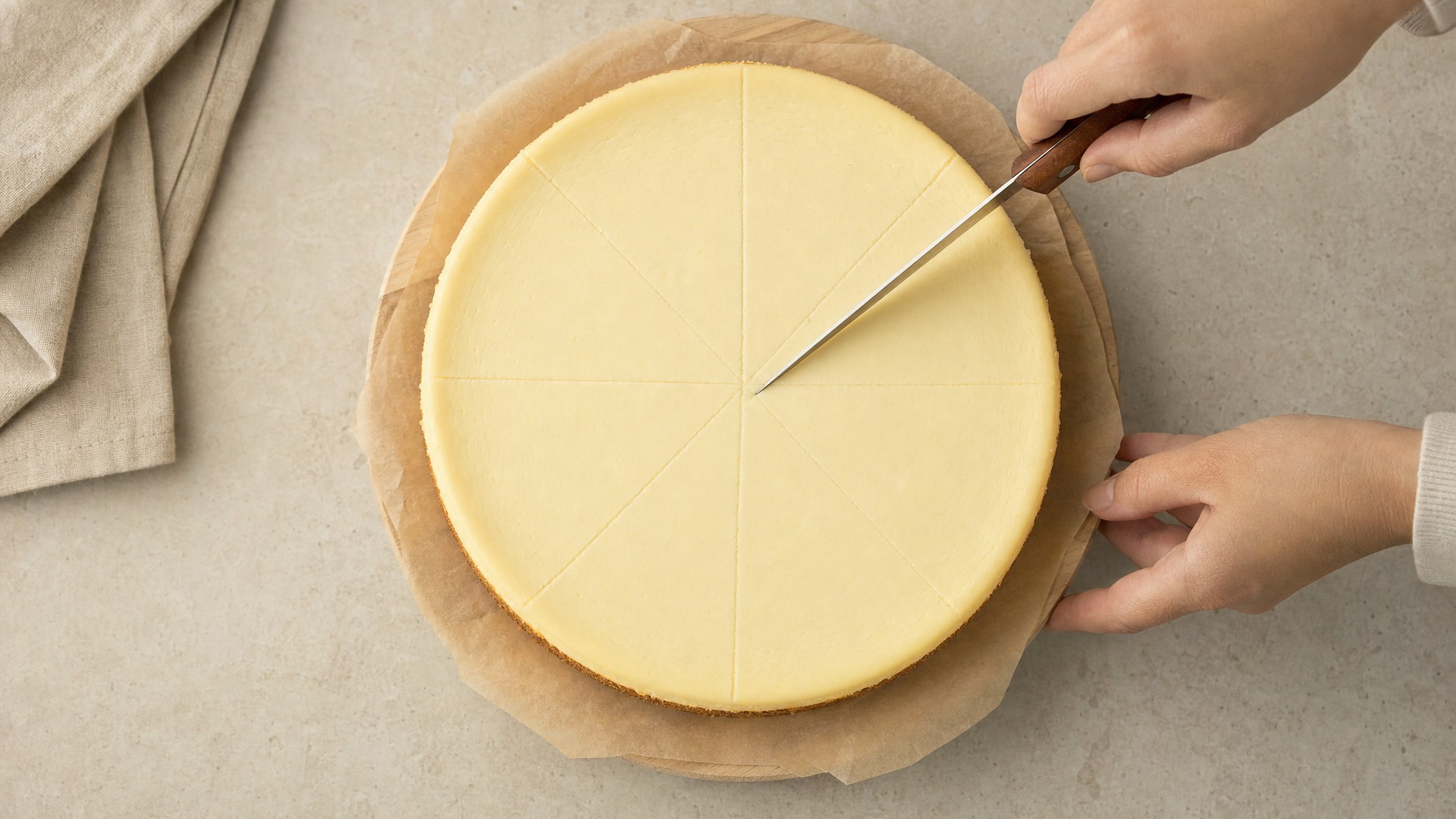Overhead view of a cheesecake marked into even wedges
