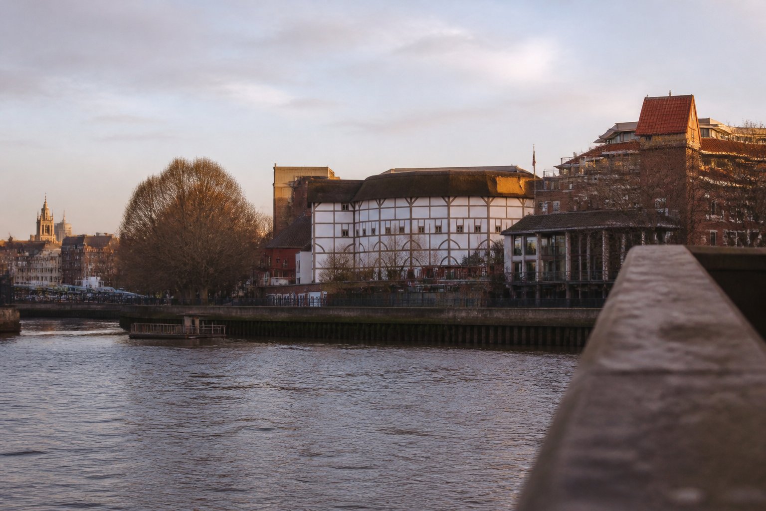 The River Thames at dusk with historic Bankside architecture across the water