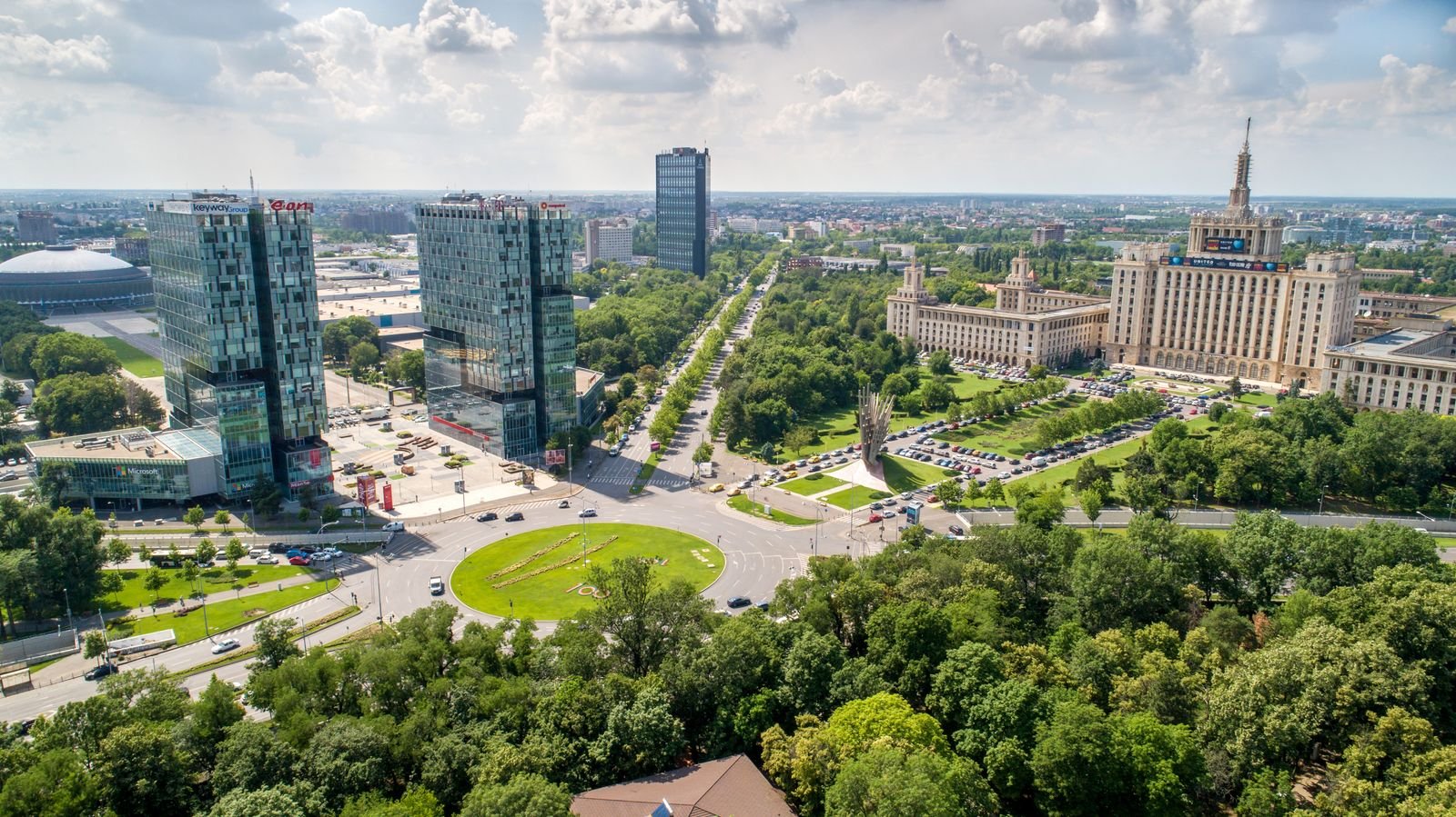 Modern Bucharest skyline with office towers, broad boulevards, and green spaces