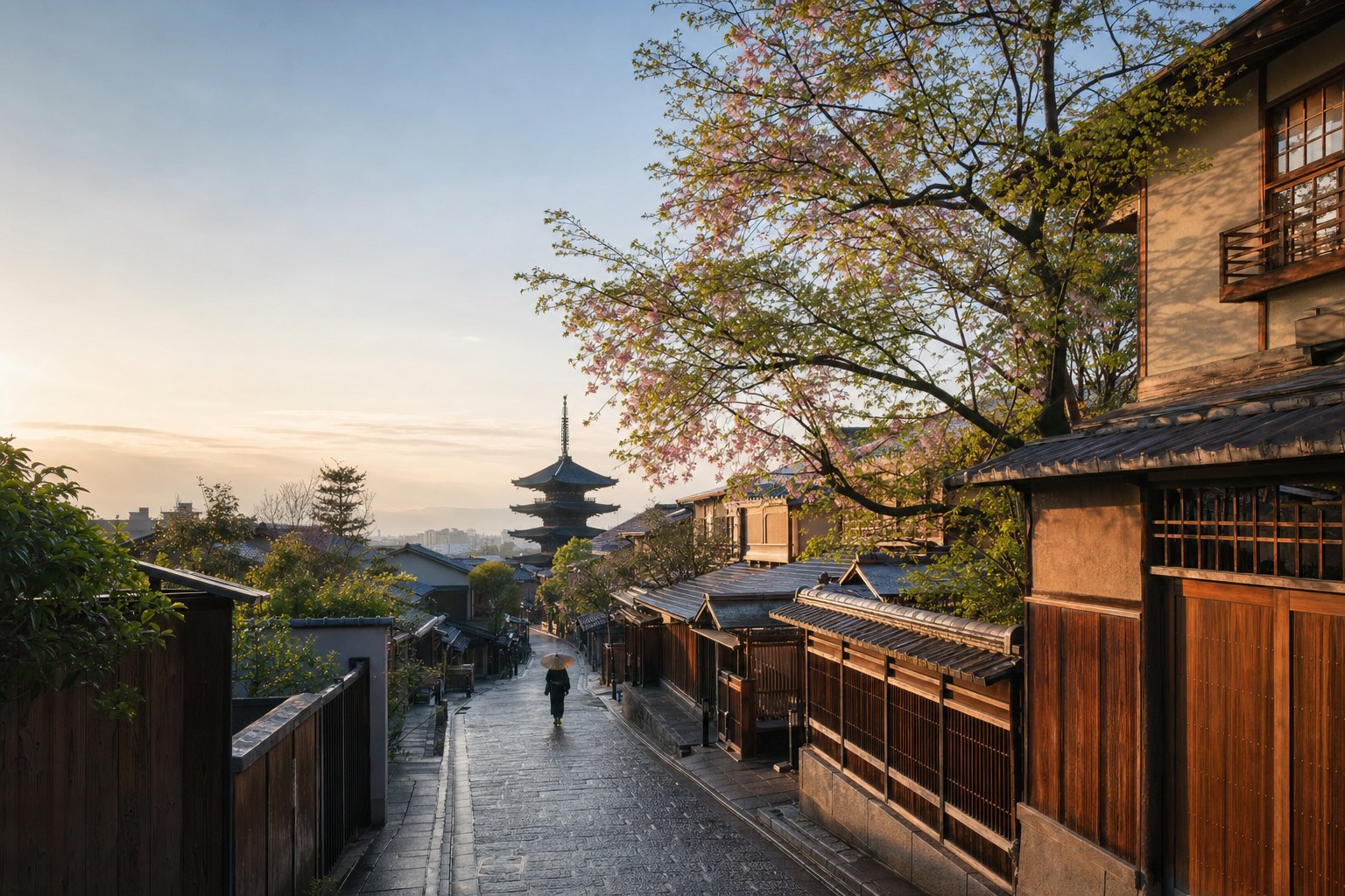 A pagoda and spring blossoms above a historic Kyoto lane
