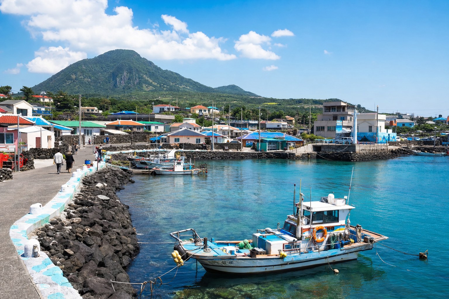 Jeju Island seaside village with fishing boats and a mountain backdrop