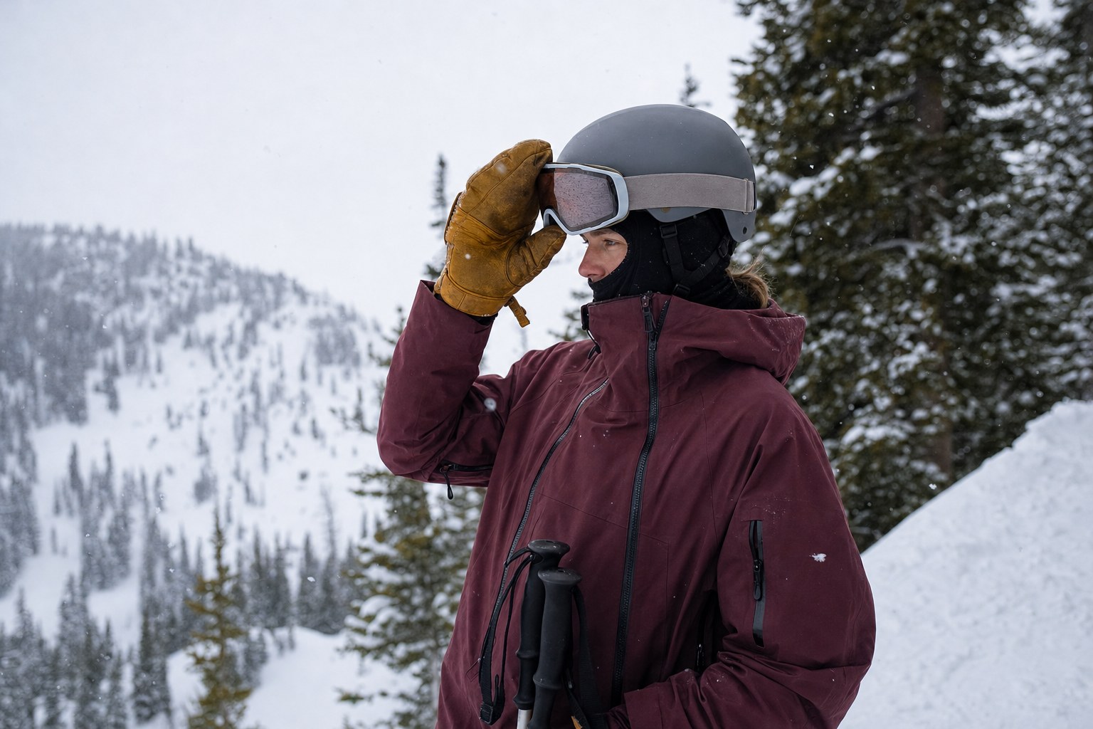 Skier lifting fogged goggles on a snowy mountain ridge