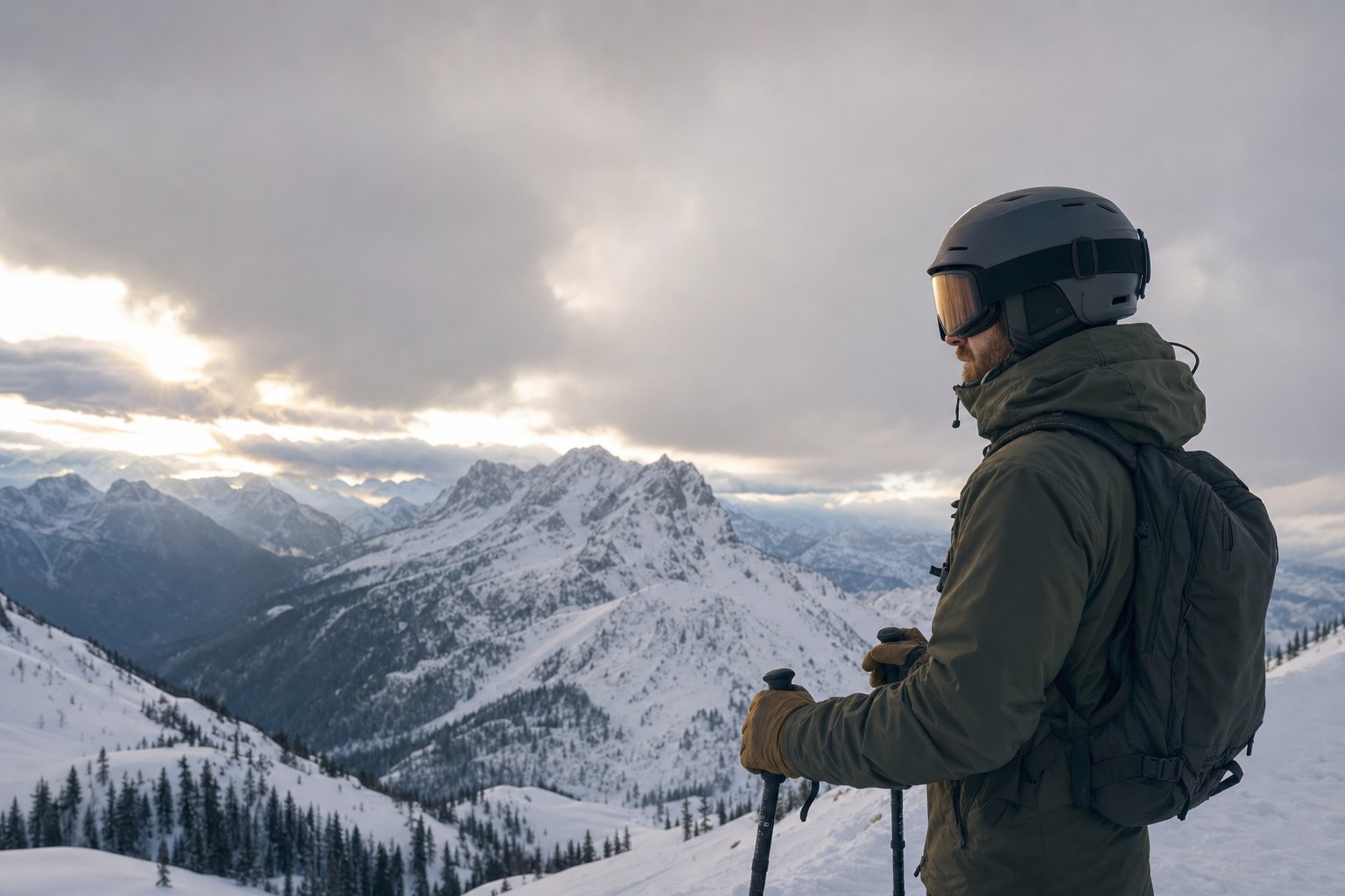 Skier in amber-lens goggles looking across a cloudy mountain range