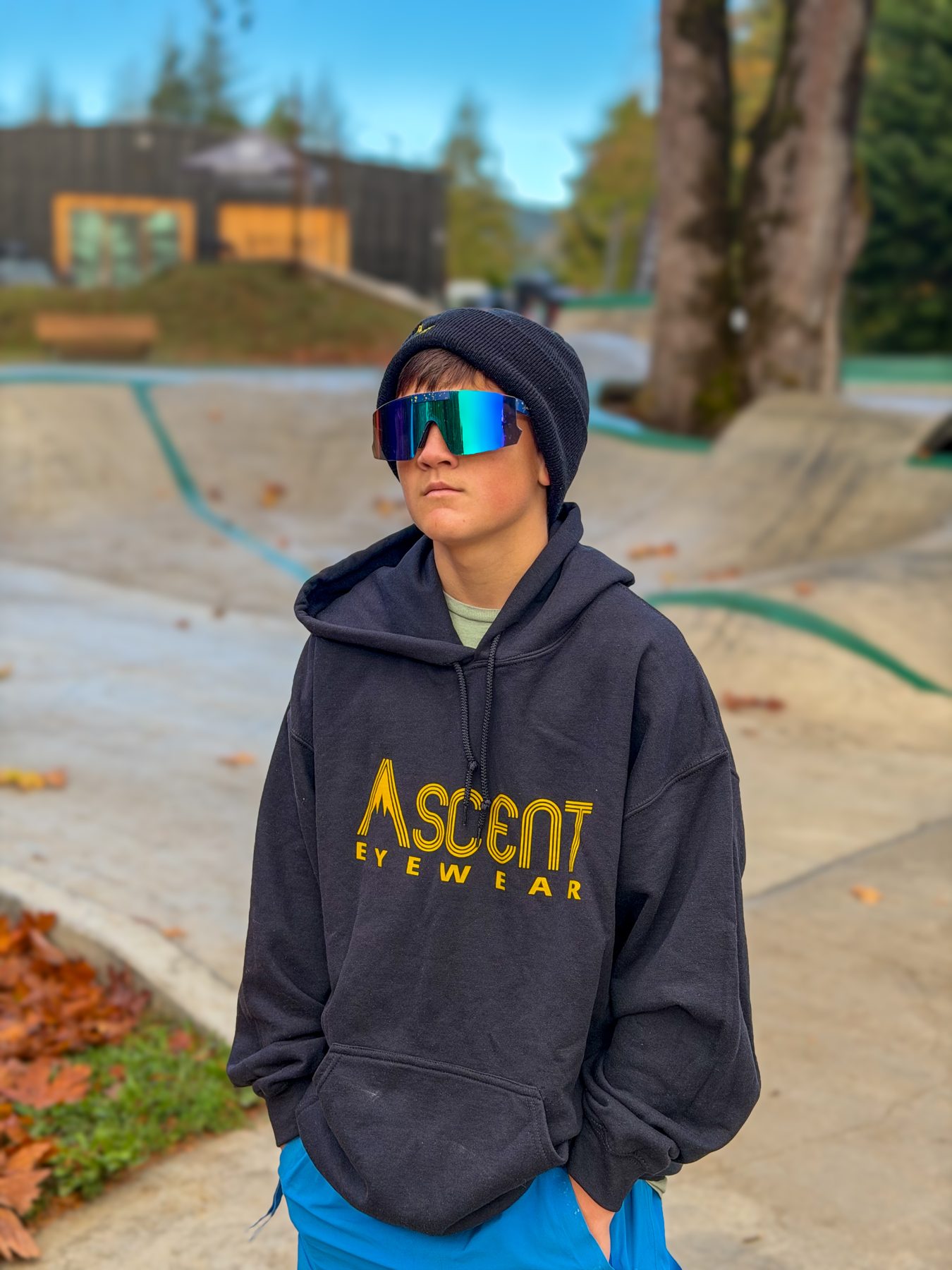Bear wearing mirrored Ascent flip-up sunglasses and a hoodie at the skatepark