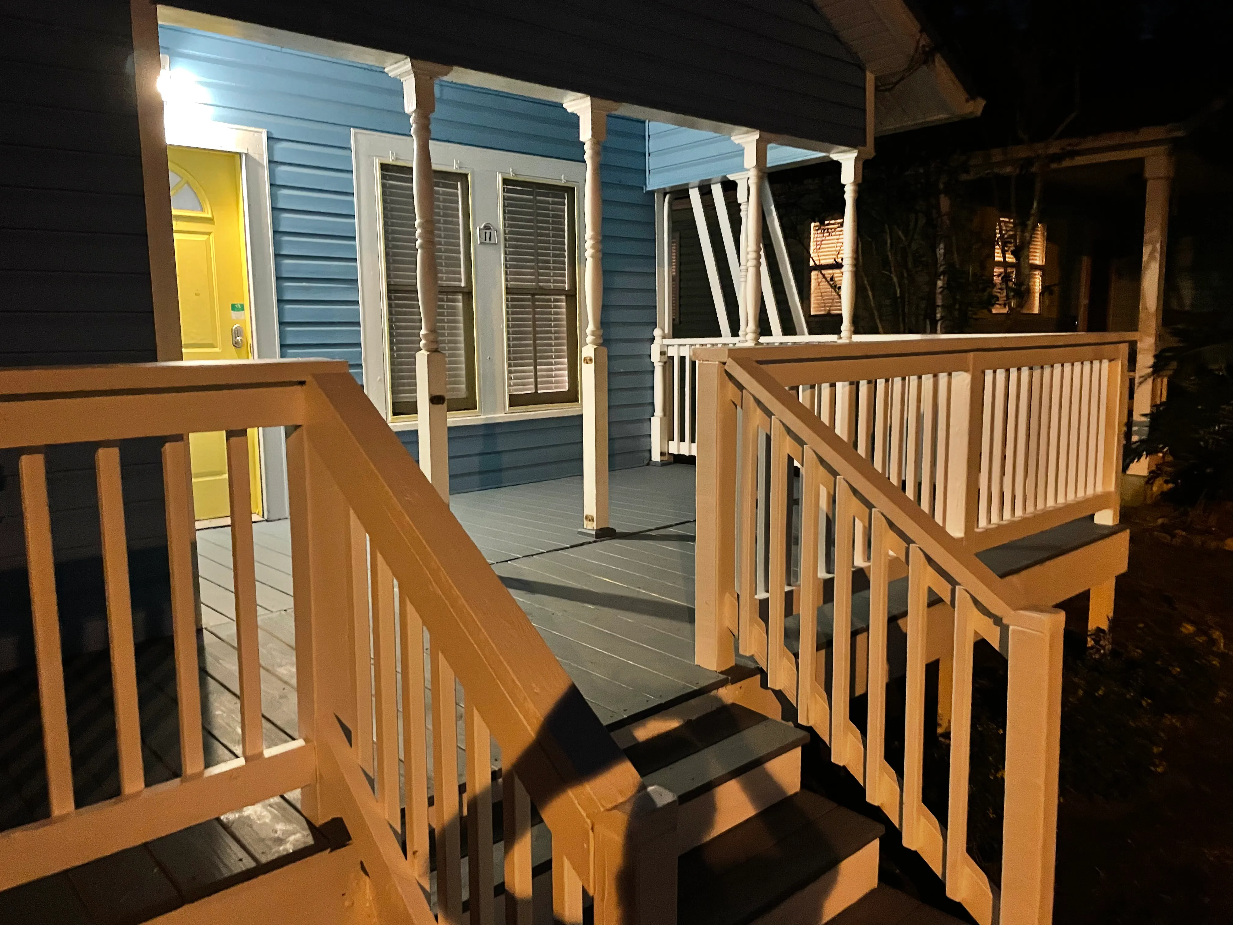 Freshly painted blue Florida home with a finished porch