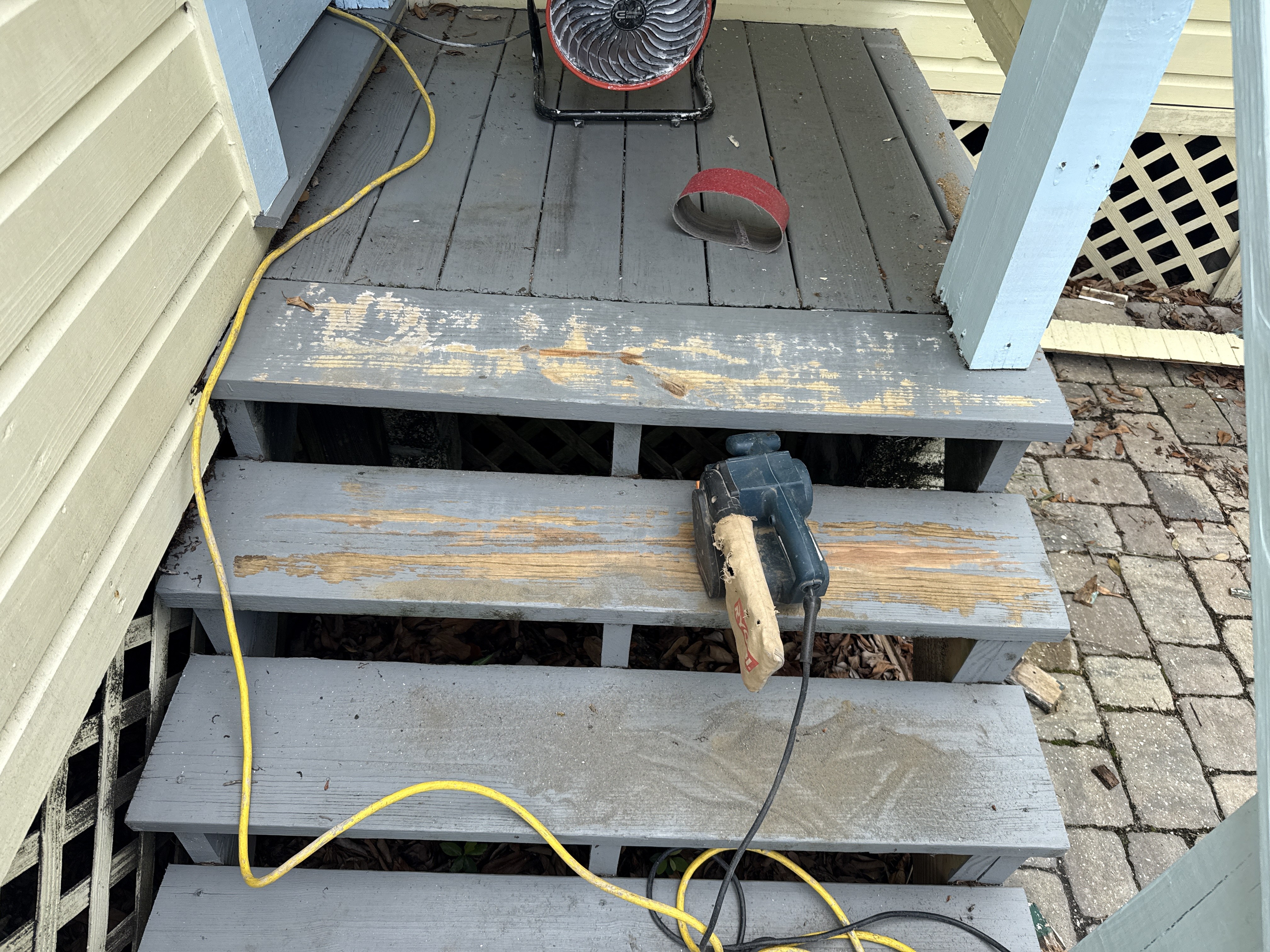 Entry steps being sanded and prepared for paint