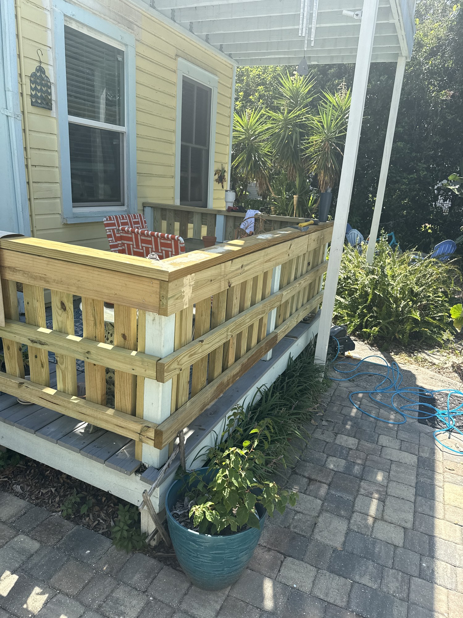 Rebuilt porch railing and exterior details at the historic property
