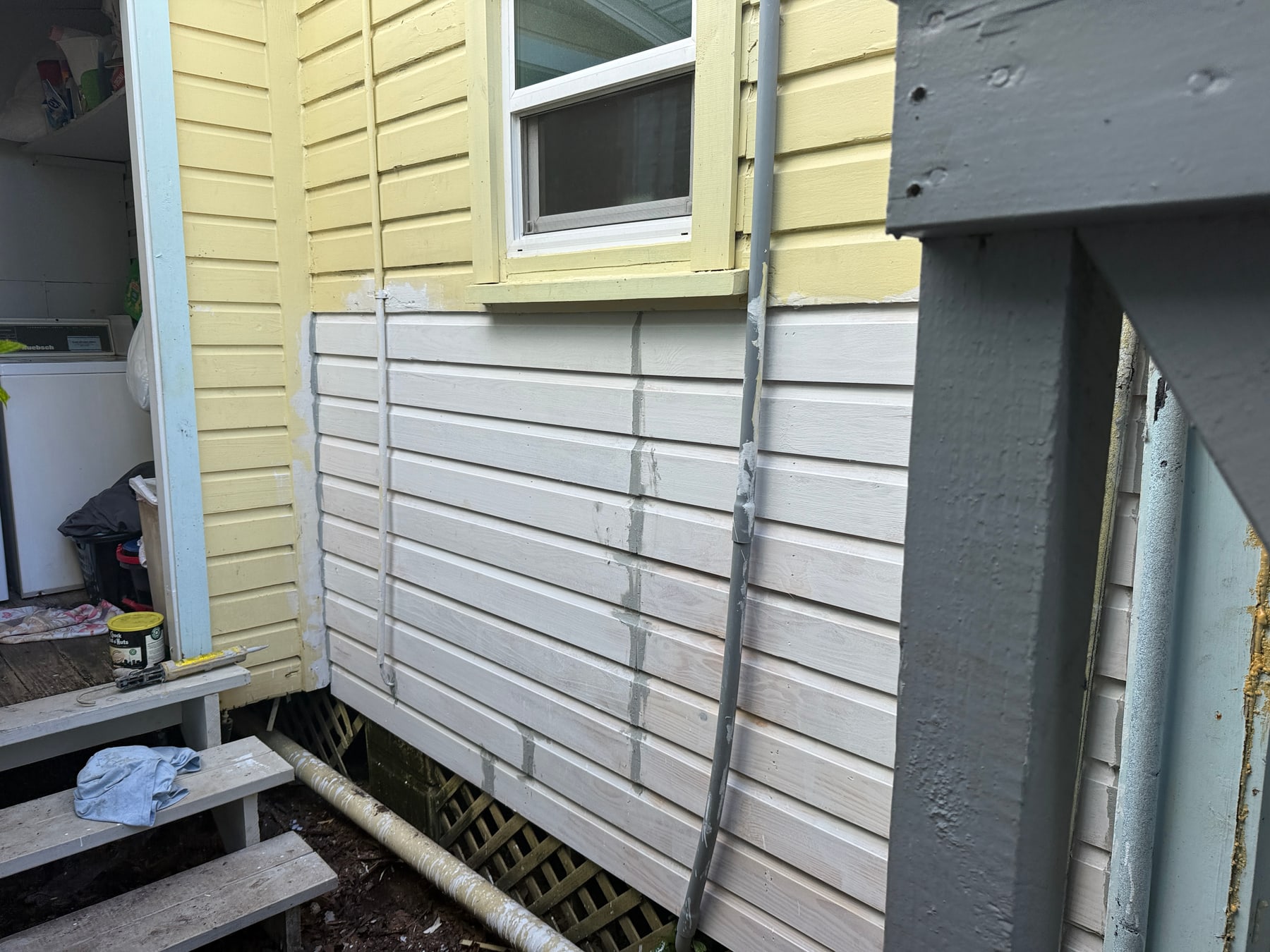 Repaired exterior siding primed and ready for paint at the historic St. Augustine home