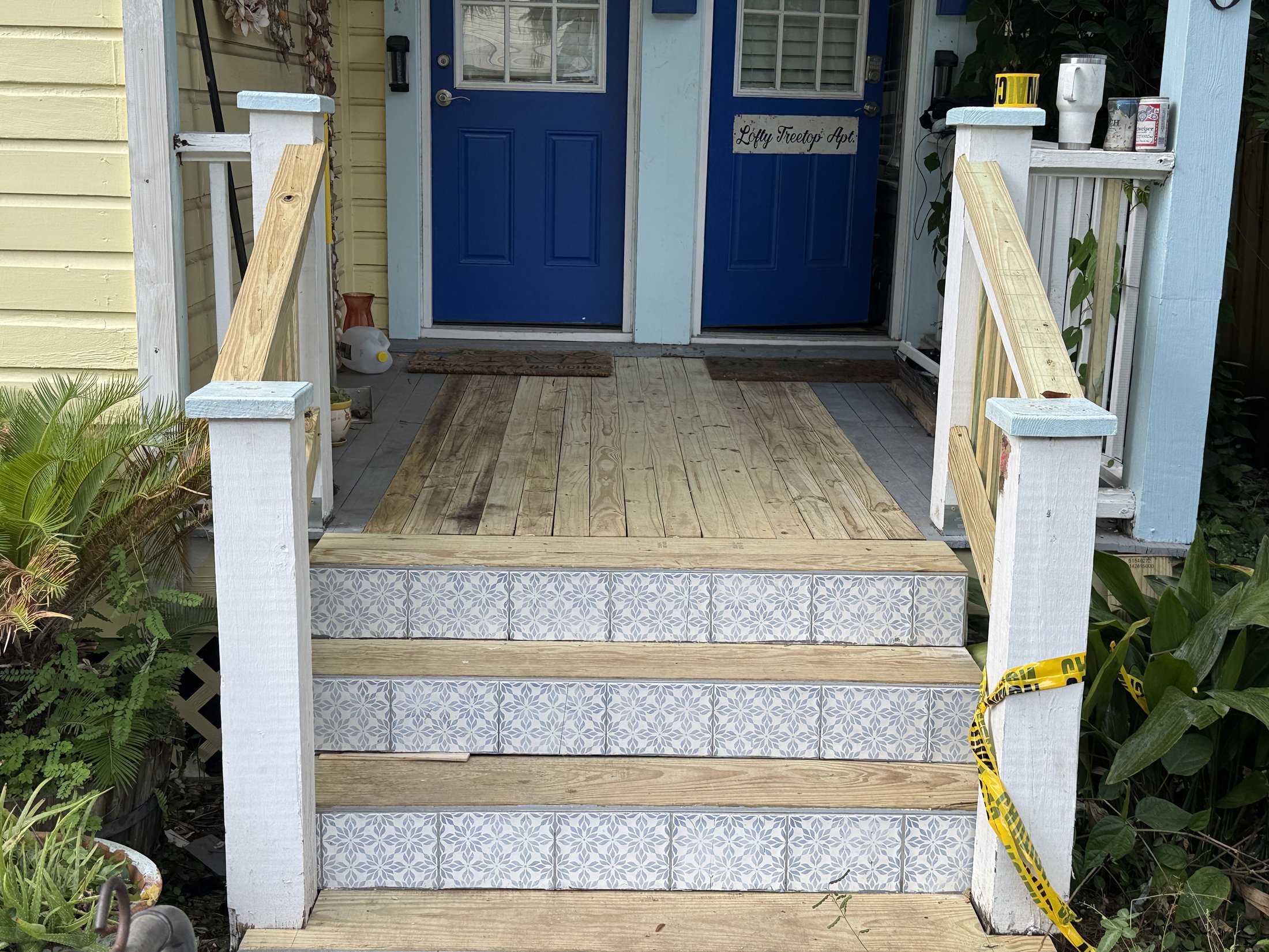 New porch boards and tiled entry steps during the historic home restoration