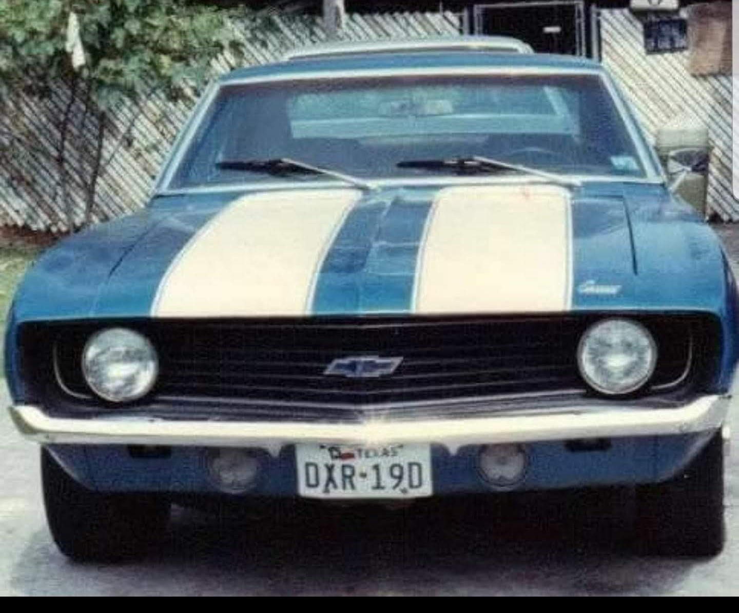 Finished blue 1969 Chevrolet Camaro with white stripes in a driveway