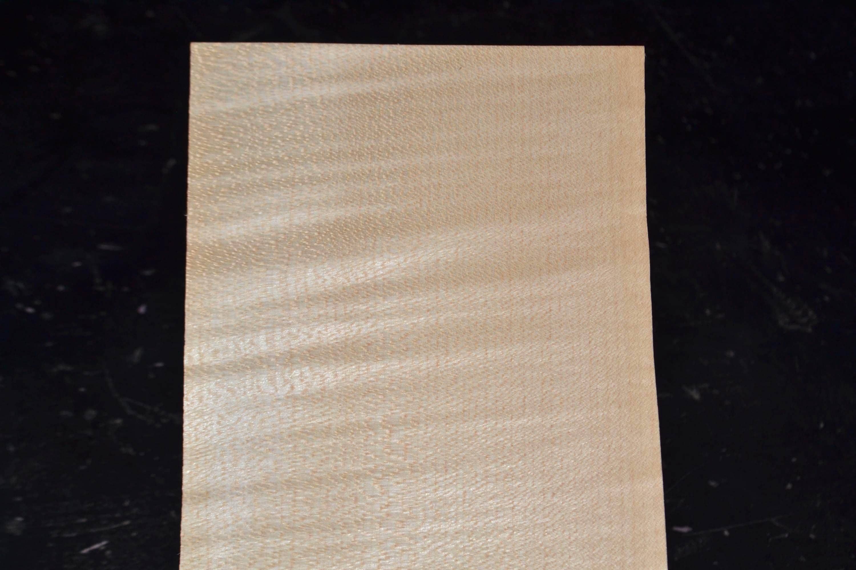 Raw wood veneer sheet showing close, detailed figure