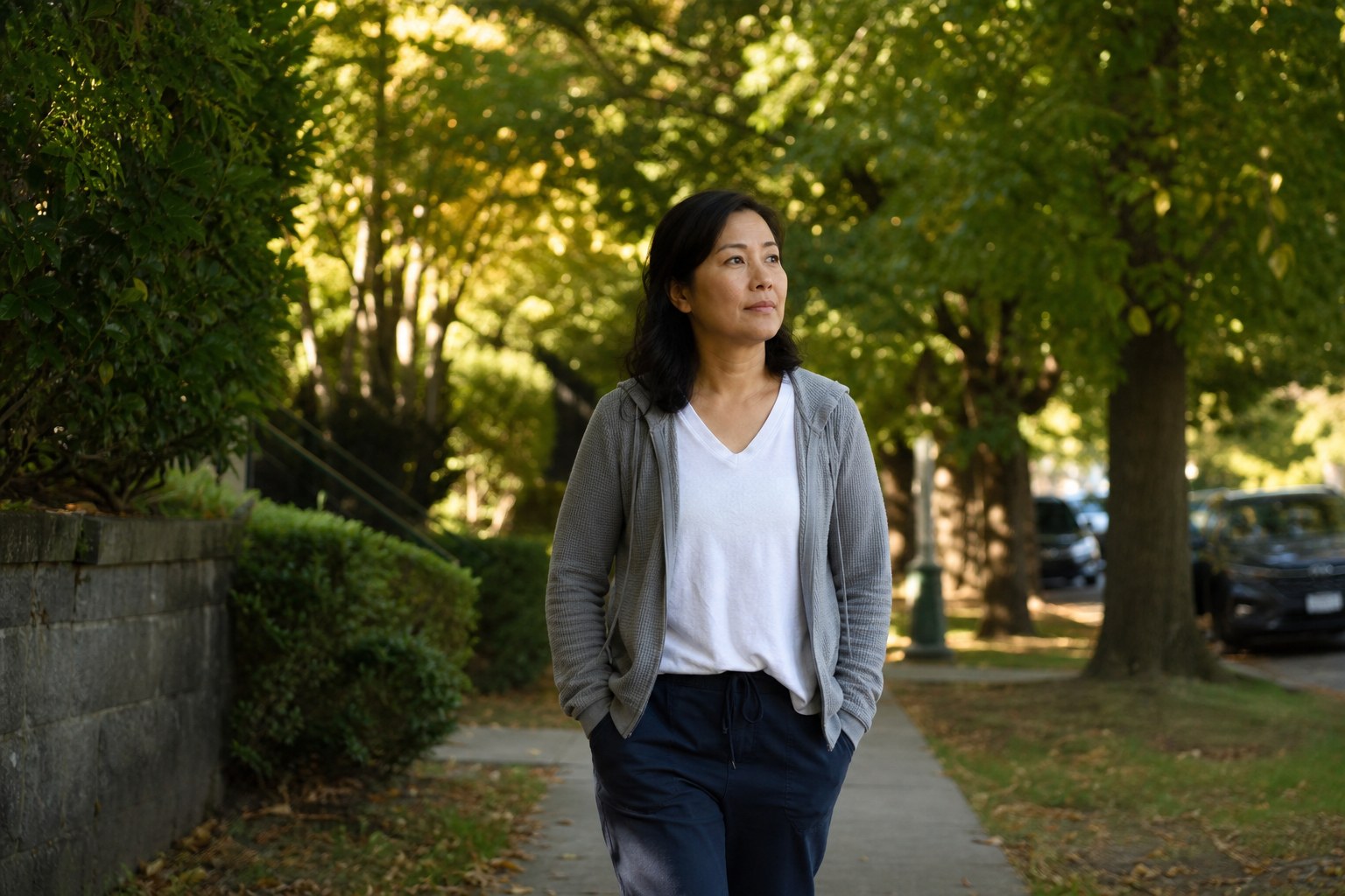 Person taking a quiet walk on a tree-lined path