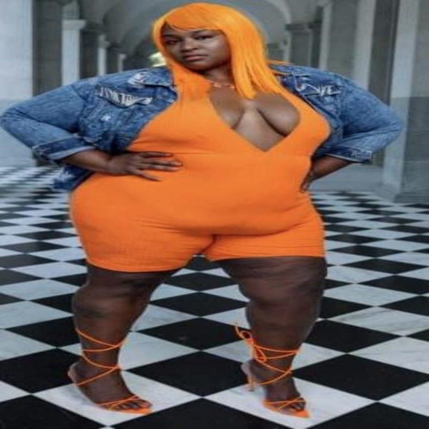 Bright orange romper and denim jacket styled for a bold birthday look
