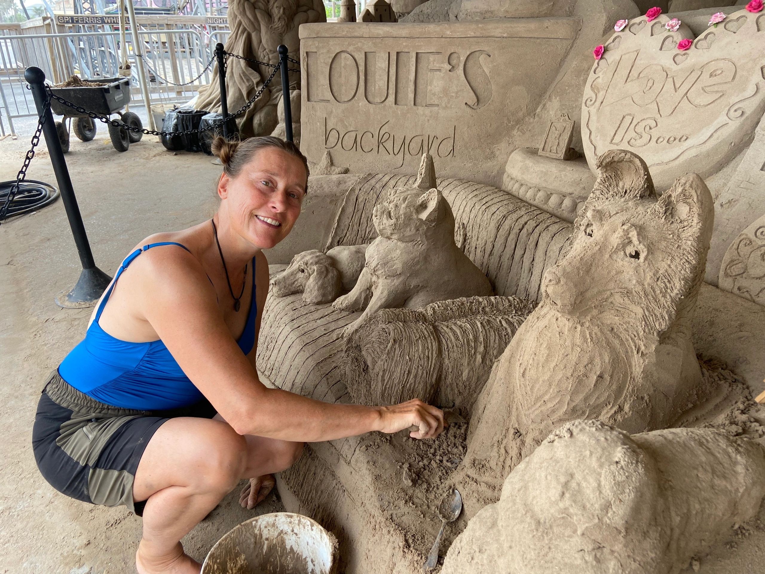 Dog-themed sand sculpture at the Village
