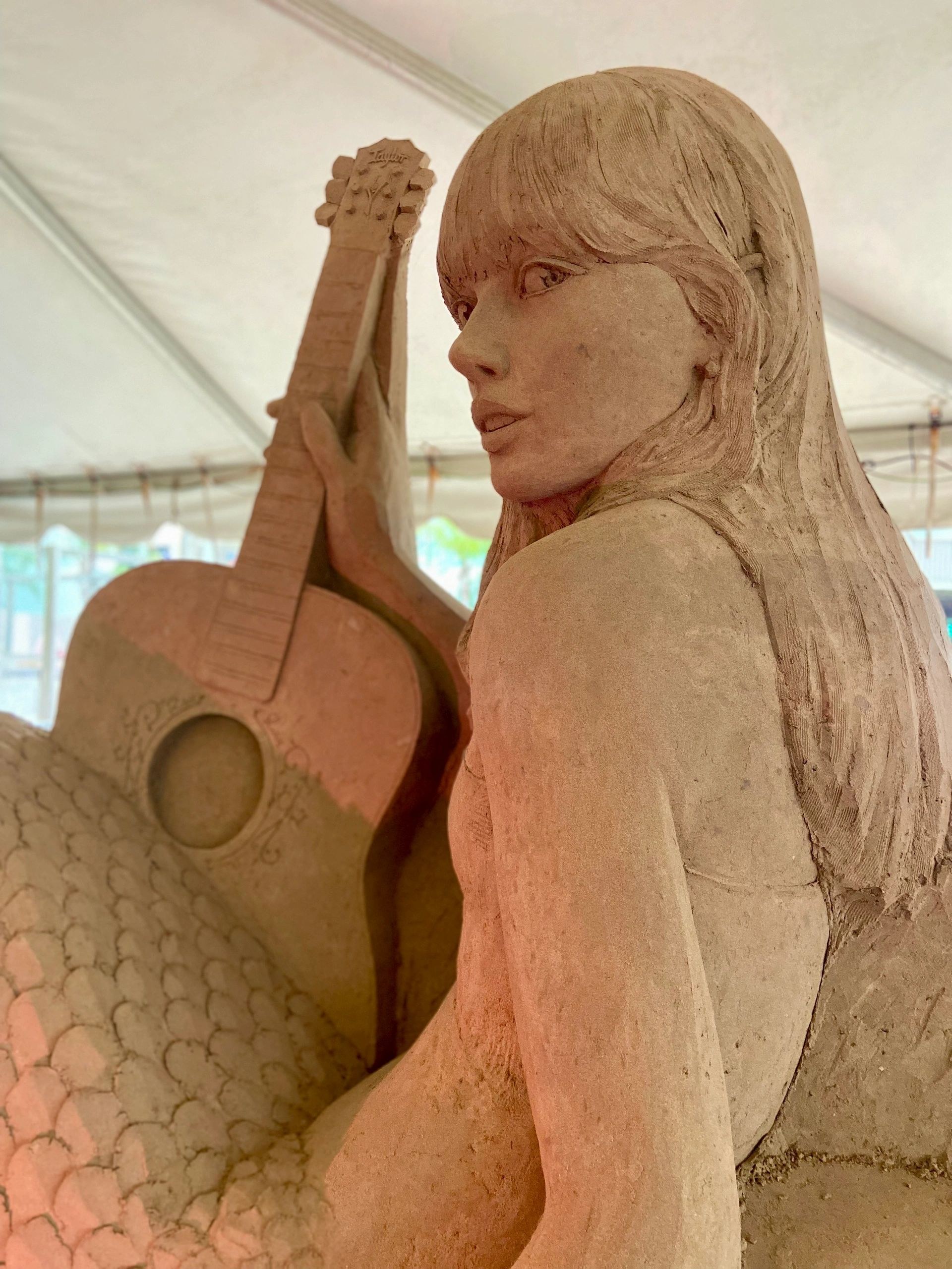 Detailed Taylor Swift as a mermaid sand sculpture at the Village