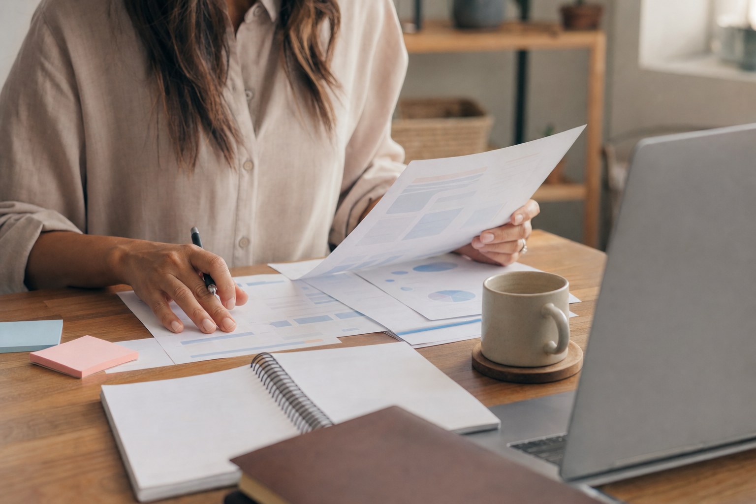 Small-business owner reviewing financial reports at a desk