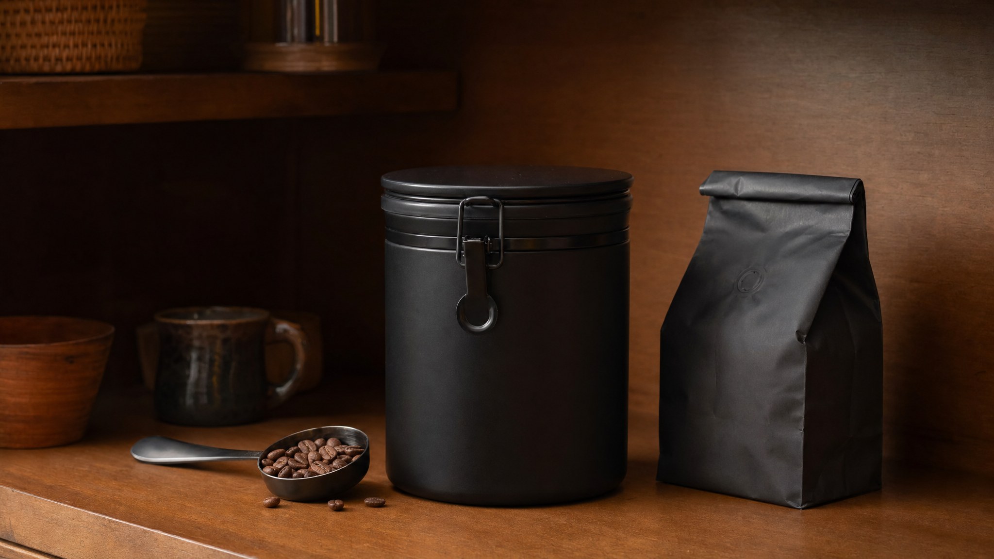 Opaque coffee canister and resealable coffee bag on a pantry shelf
