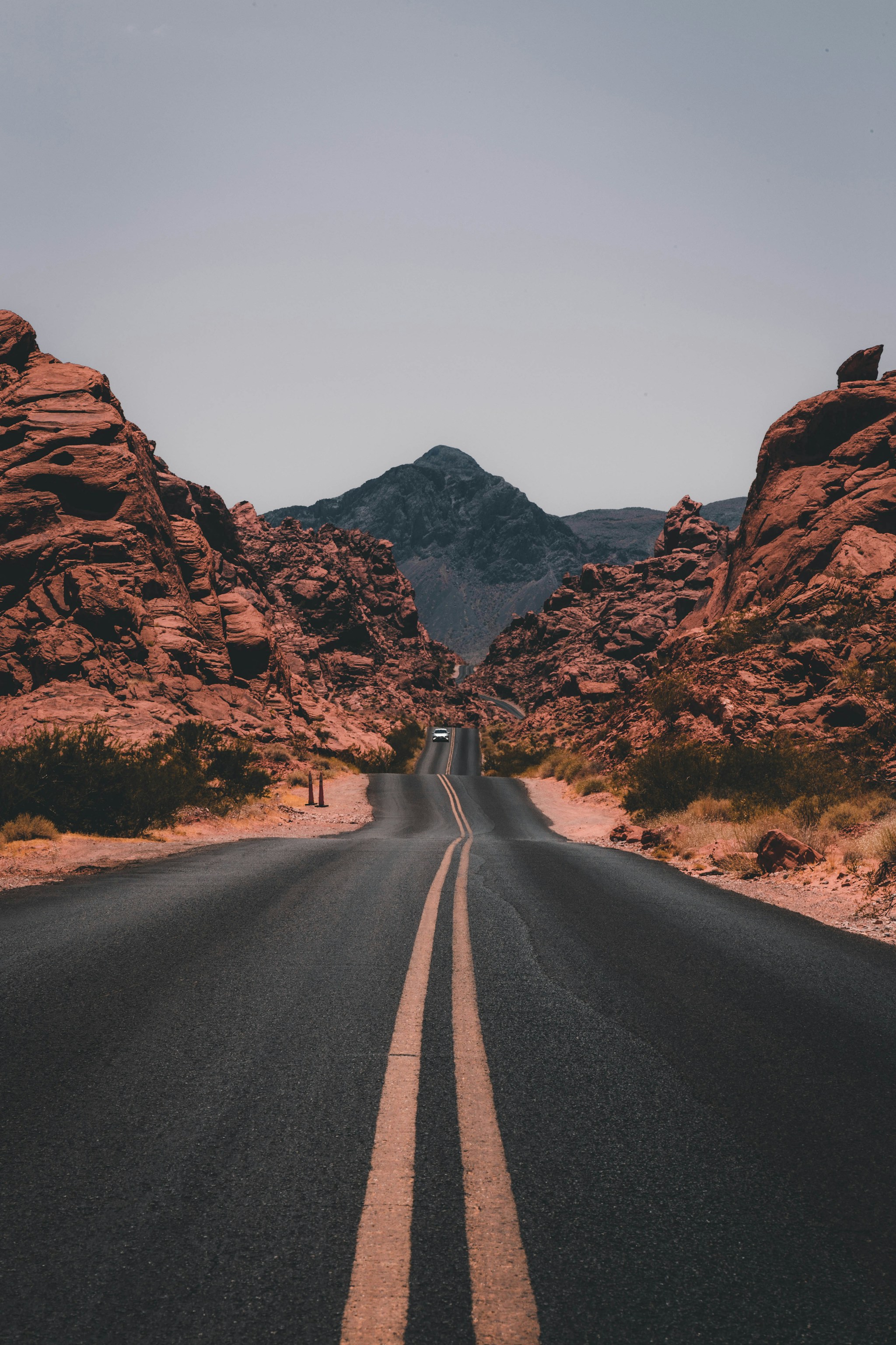 Road leading through red rock hills