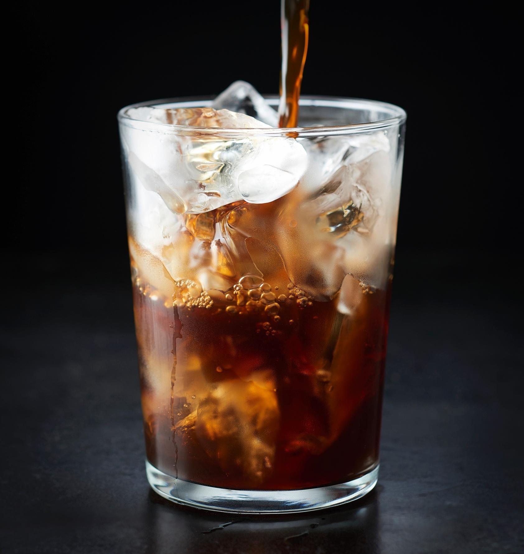 Iced cold brew coffee being poured into a glass