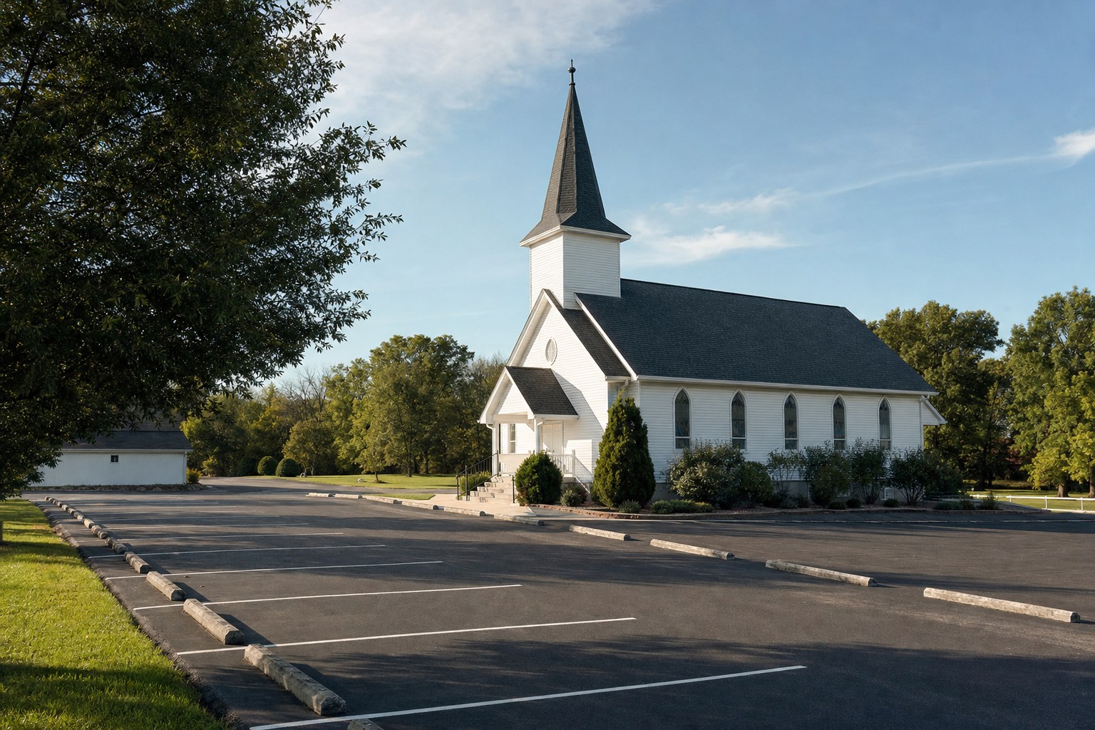 A traditional country church and parking area on a clear morning