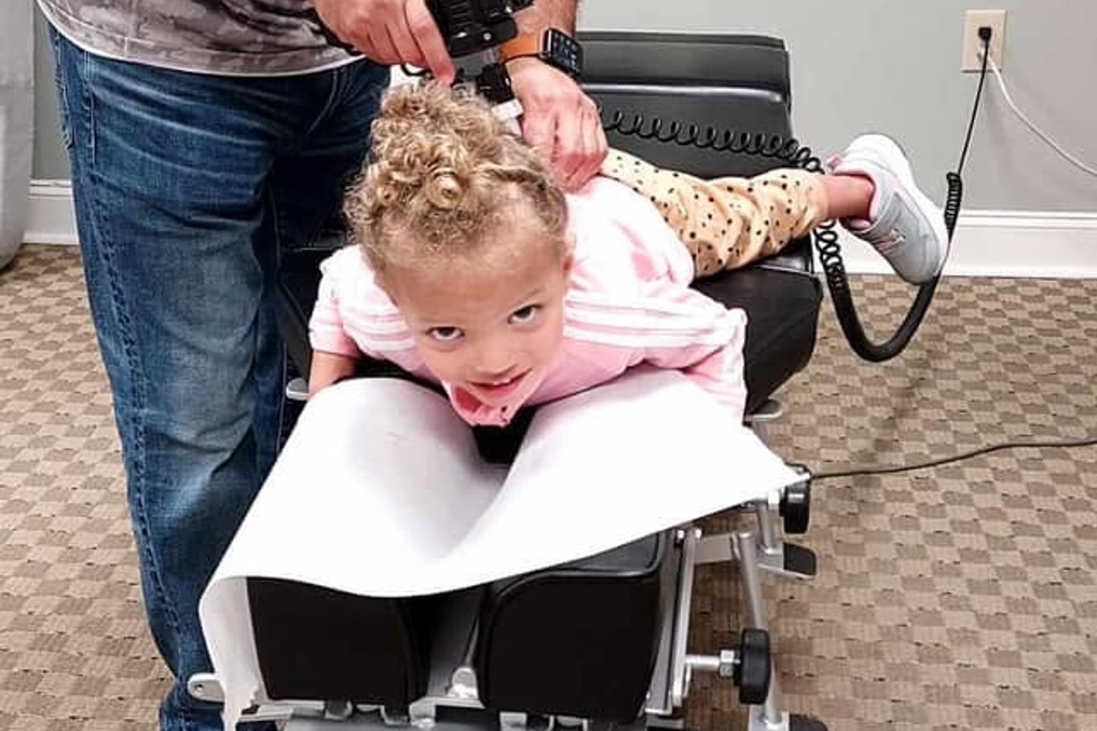 Dr. Chris providing a gentle adjustment for a young patient