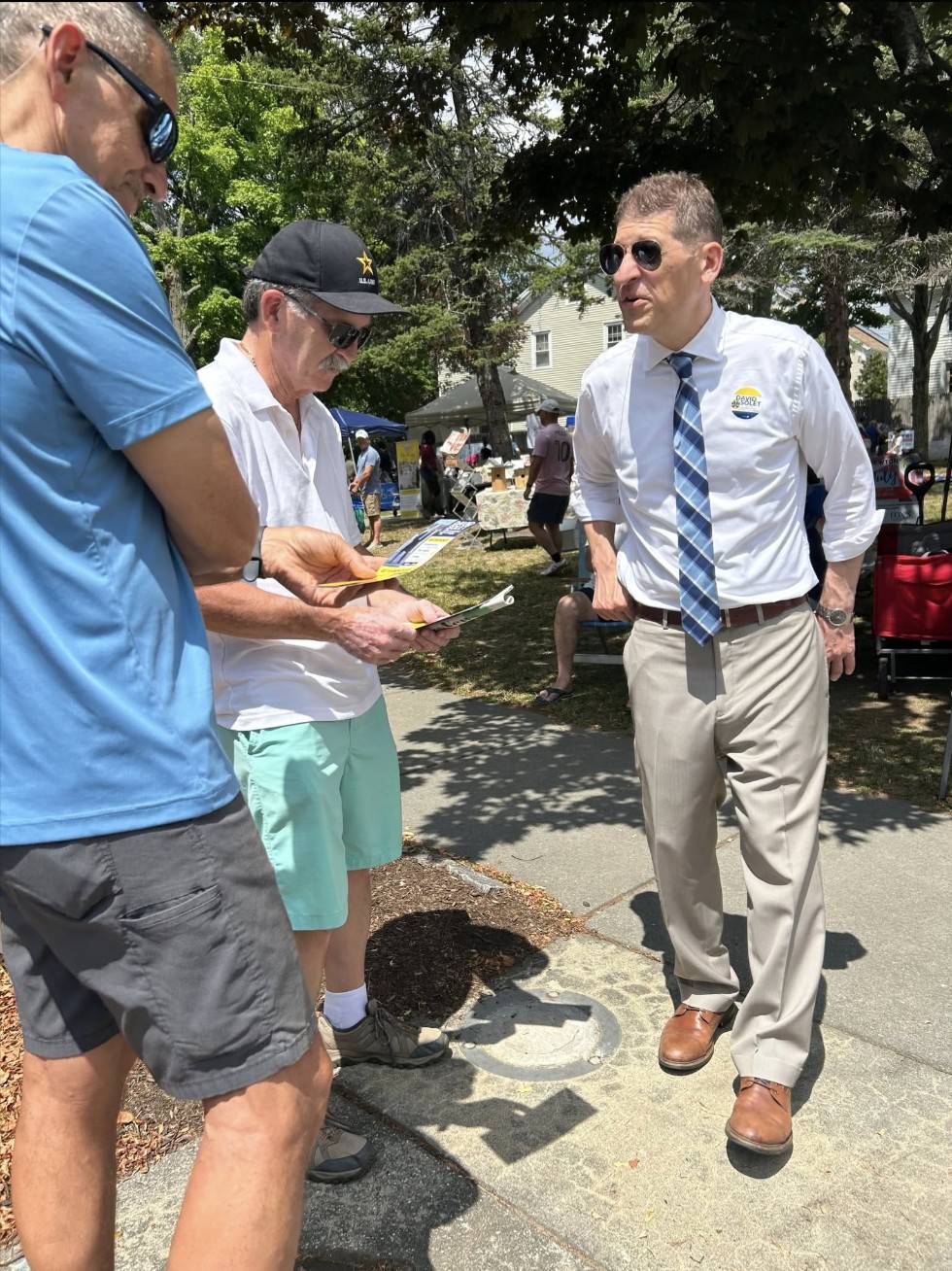 David Solet speaking with community members at an outdoor event