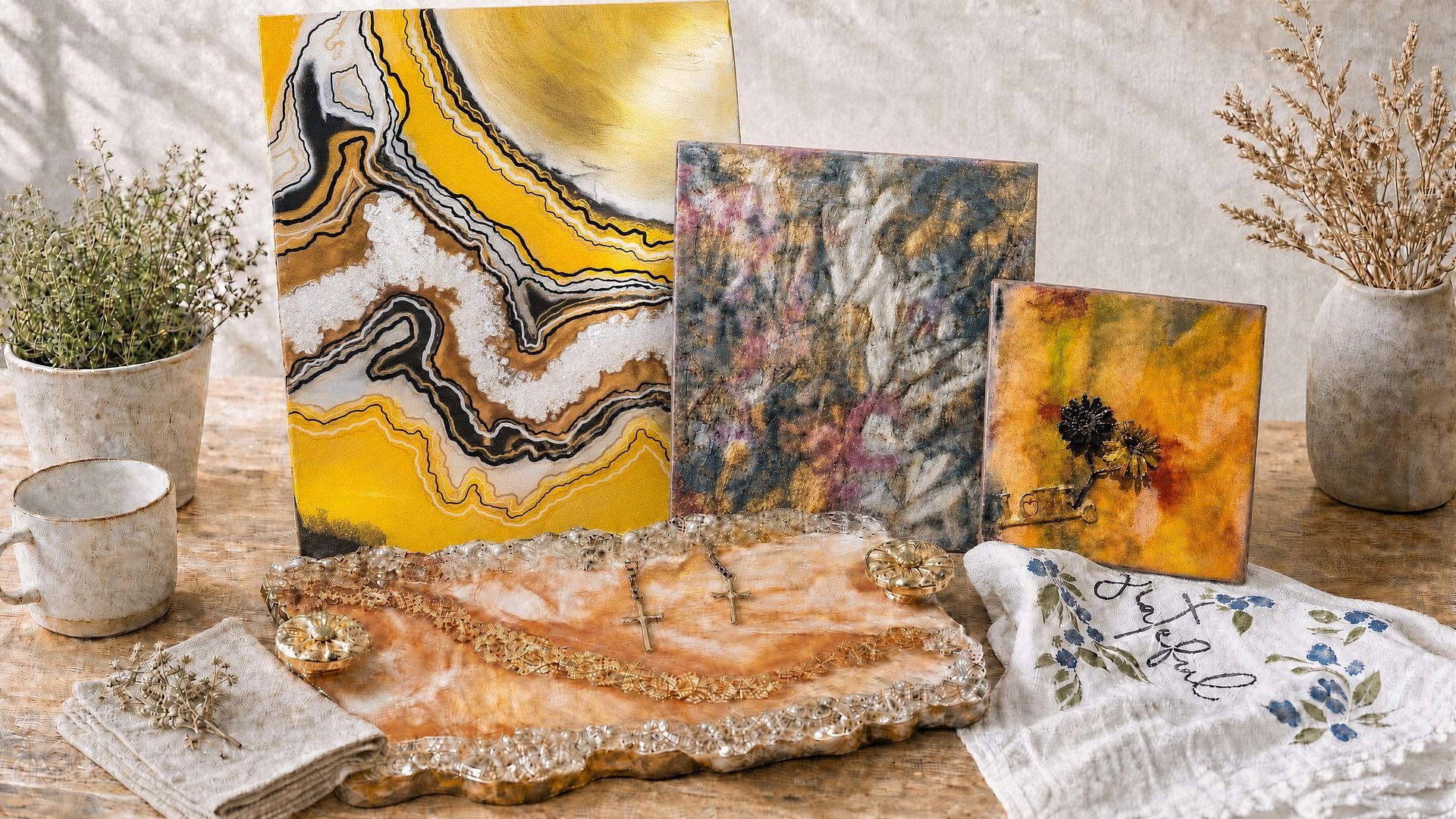 Colorful handmade art, resin tray, and patterned towels in a sunny studio