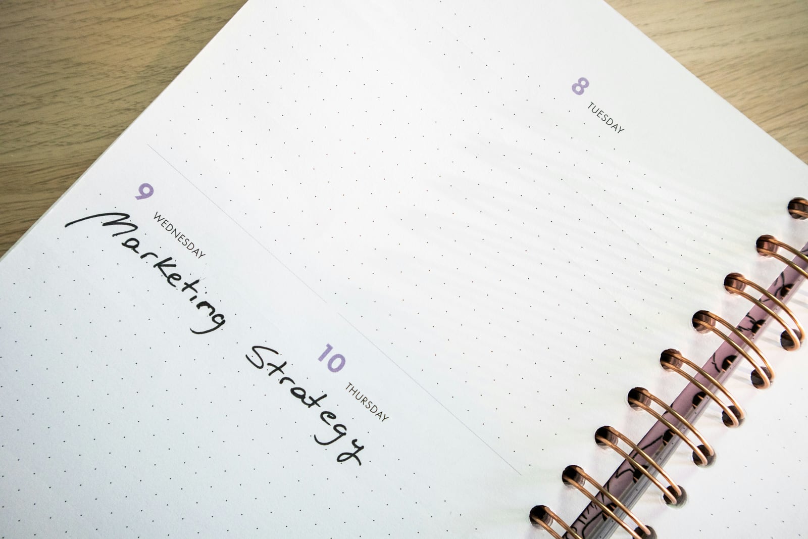 Open weekly planner on a wood table