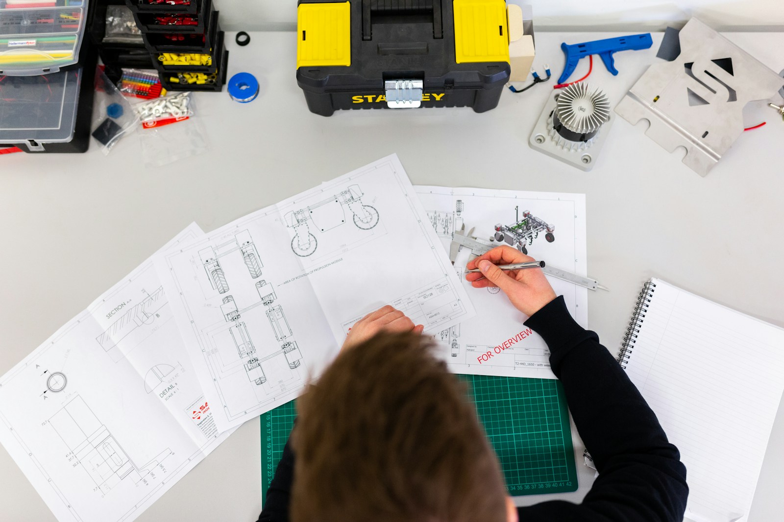Engineer reviewing manufacturing drawings and precision components
