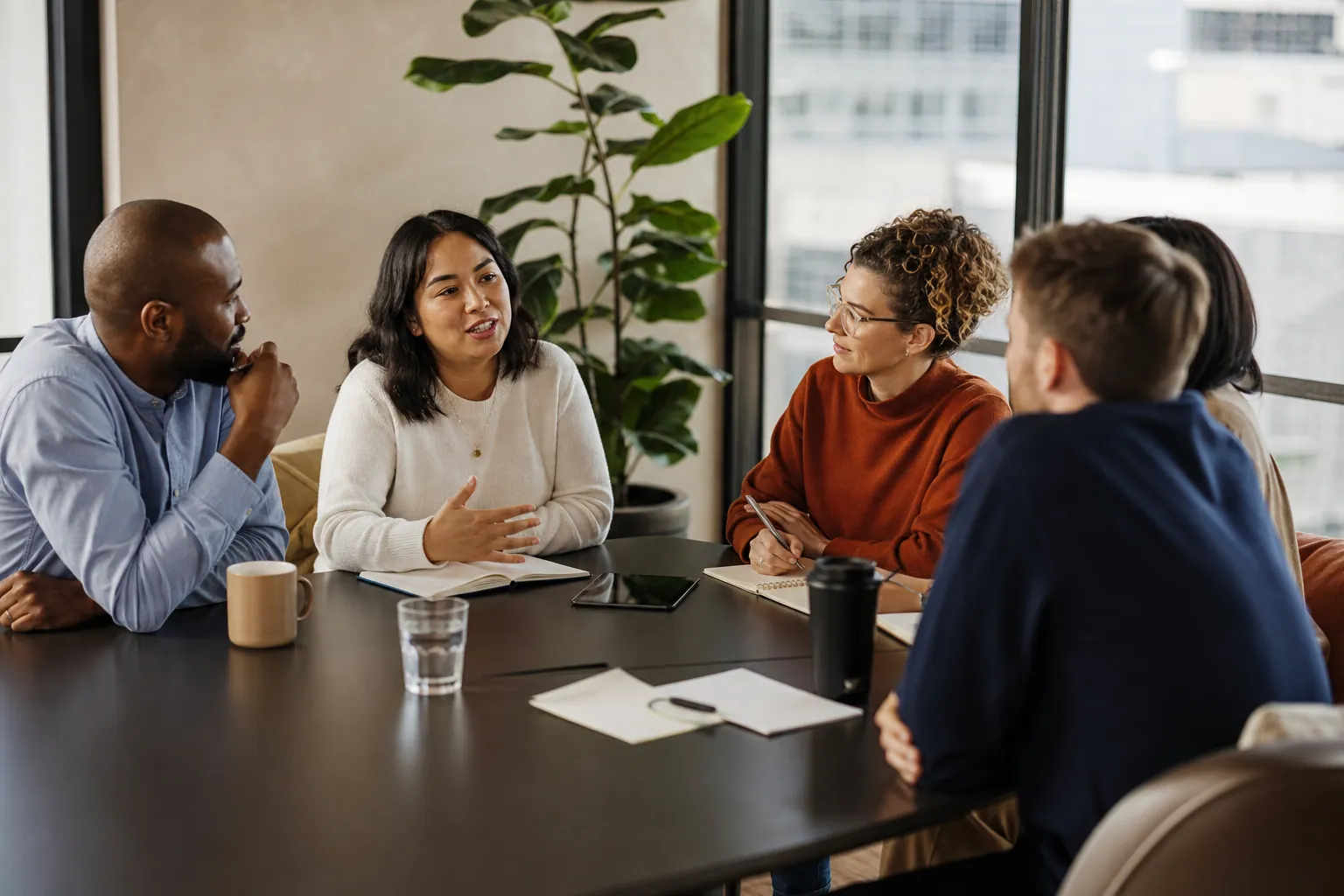Small team in a thoughtful meeting around a table