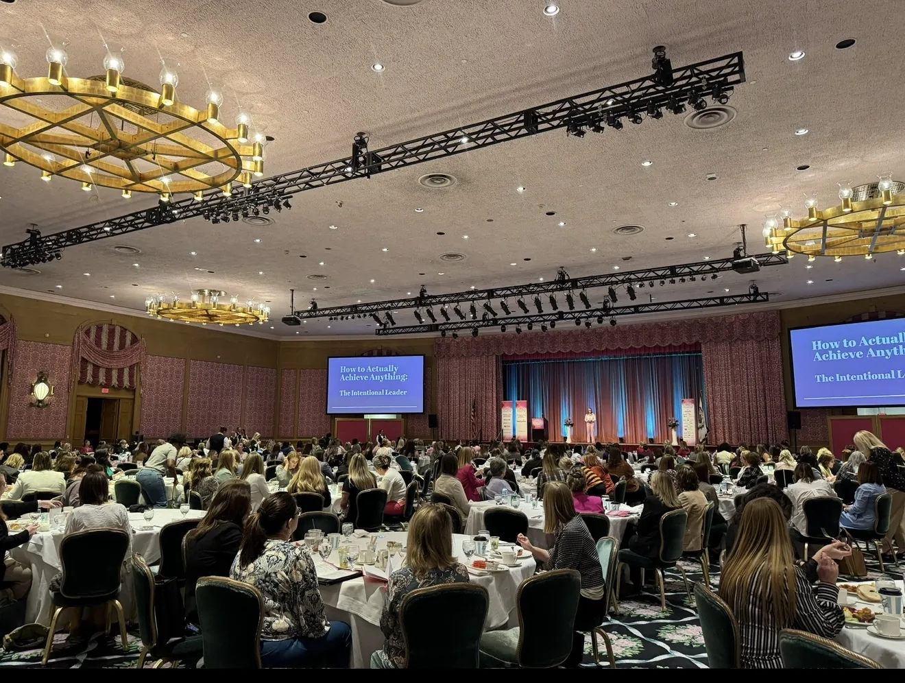 Joelle Moray speaking to a large keynote audience