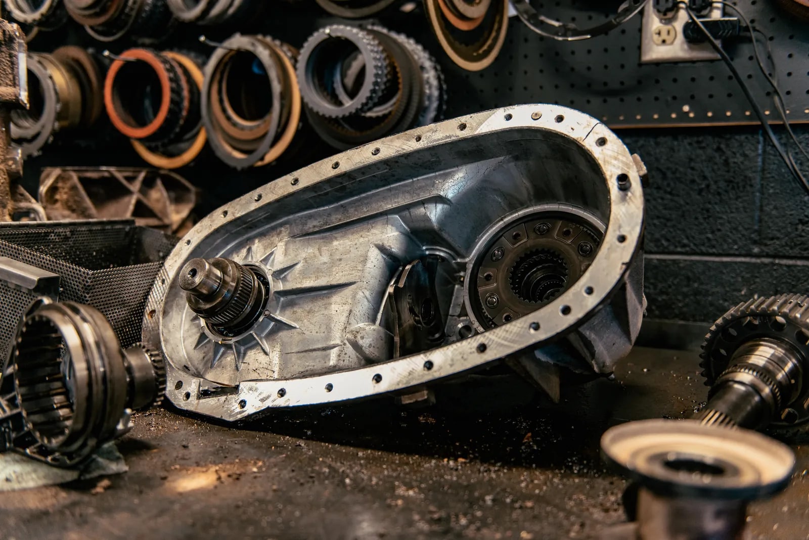 Opened automatic transmission housing and components on a repair shop workbench
